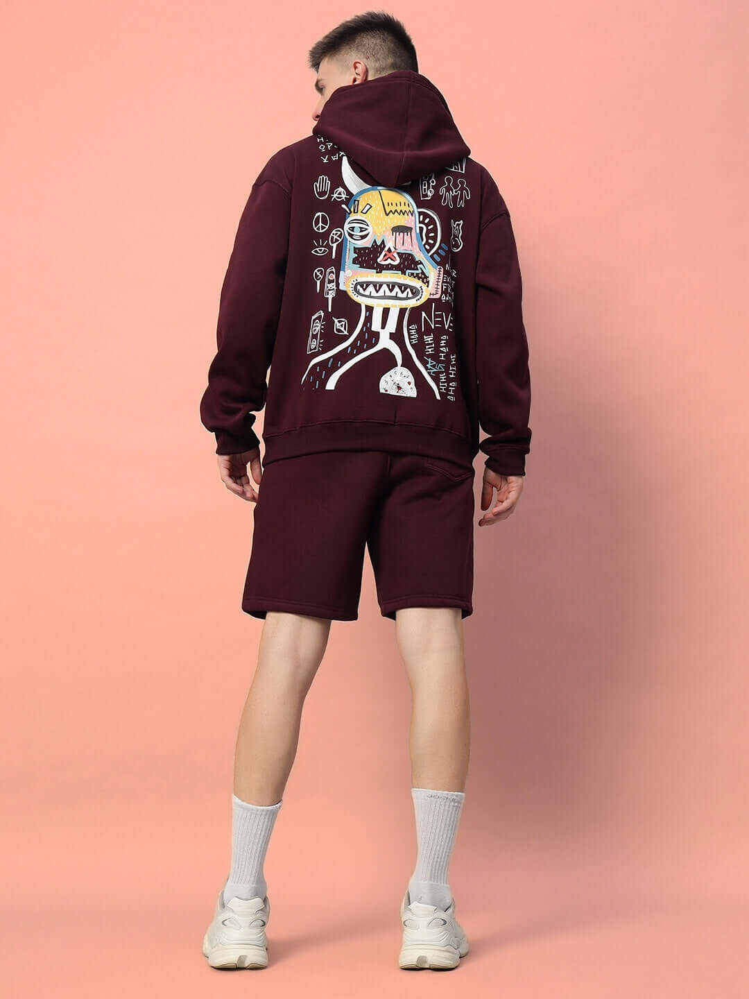 Model wearing WEARDUDS JUMBLED FLEECE CO-ORD WINE with artistic print, displaying streetwear style in cozy fleece, back view.