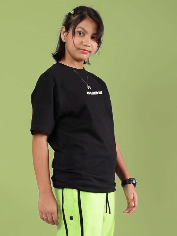 Child wearing JUMBO T-SHIRT FOR BOYS & GIRLS BLACK with modern oversized fit, showcasing trendy and comfortable style.