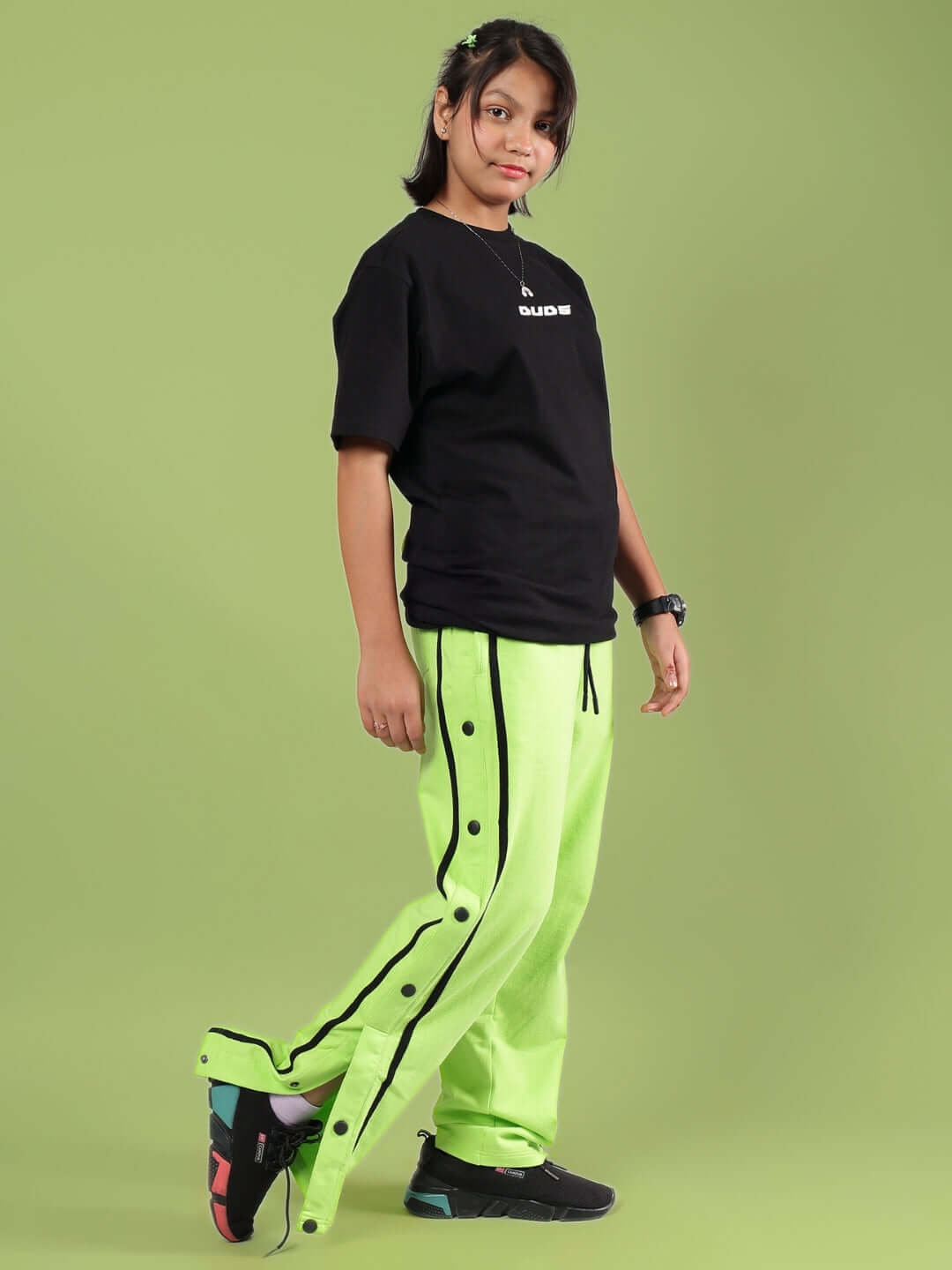 Child wearing JUMBO CO-ORD FOR BOYS & GIRLS BLACK-NEON in a stylish pose. Made-to-order fashion by DUDS.