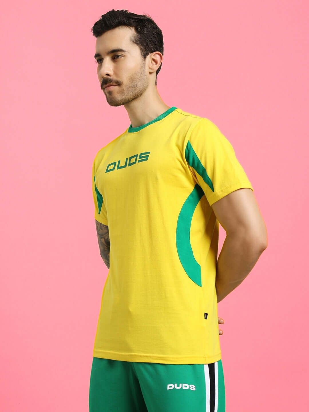 Man wearing JUMPY REGULAR FIT T-SHIRT YELLOW with green accents on pink background