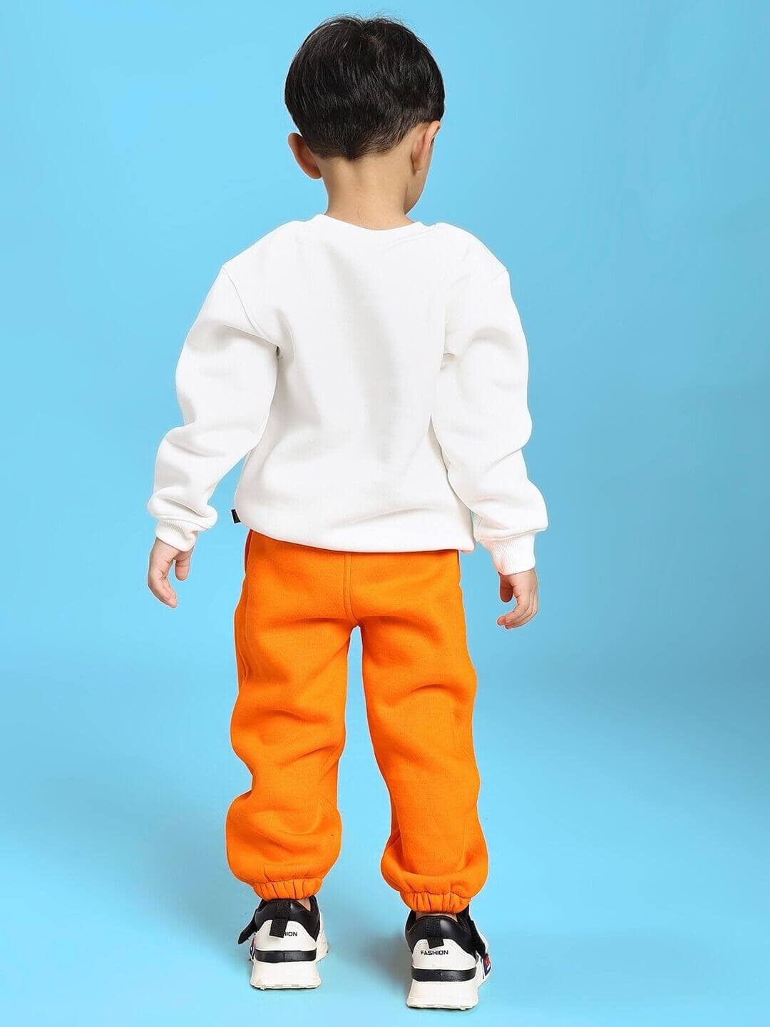 Child wearing JUMPYJOY CO-ORD FOR BOYS AND GIRLS WHITE ORANGE standing against blue background