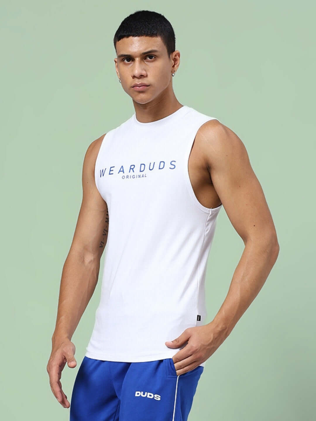 Man wearing KICKSHAW GYM SLEEVELESS T-SHIRT WHITE, ideal for high-performance workouts with moisture-wicking fabric.