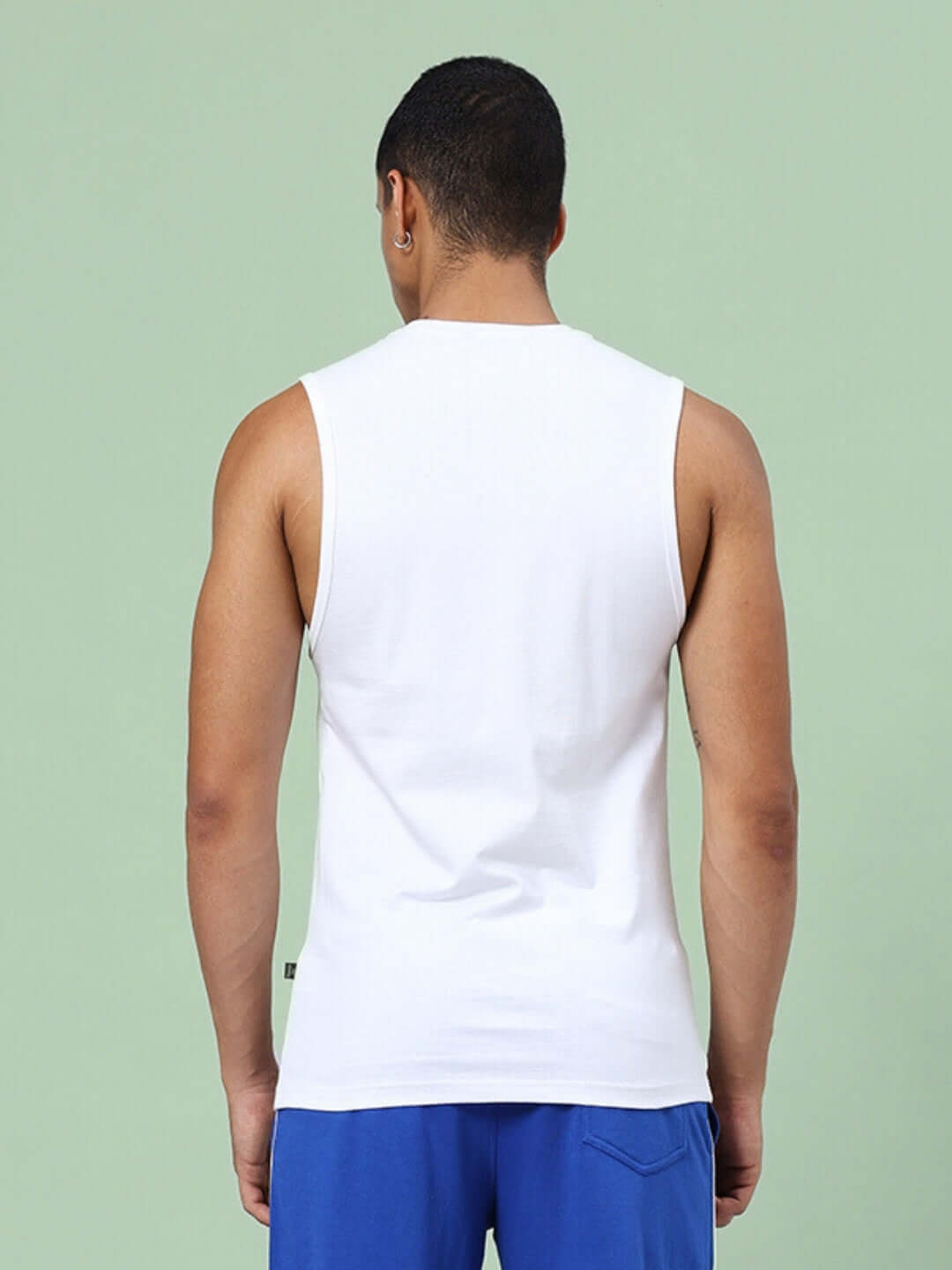 Back view of man wearing KICKSHAW GYM SLEEVELESS T-SHIRT WHITE showcasing its fit and design.