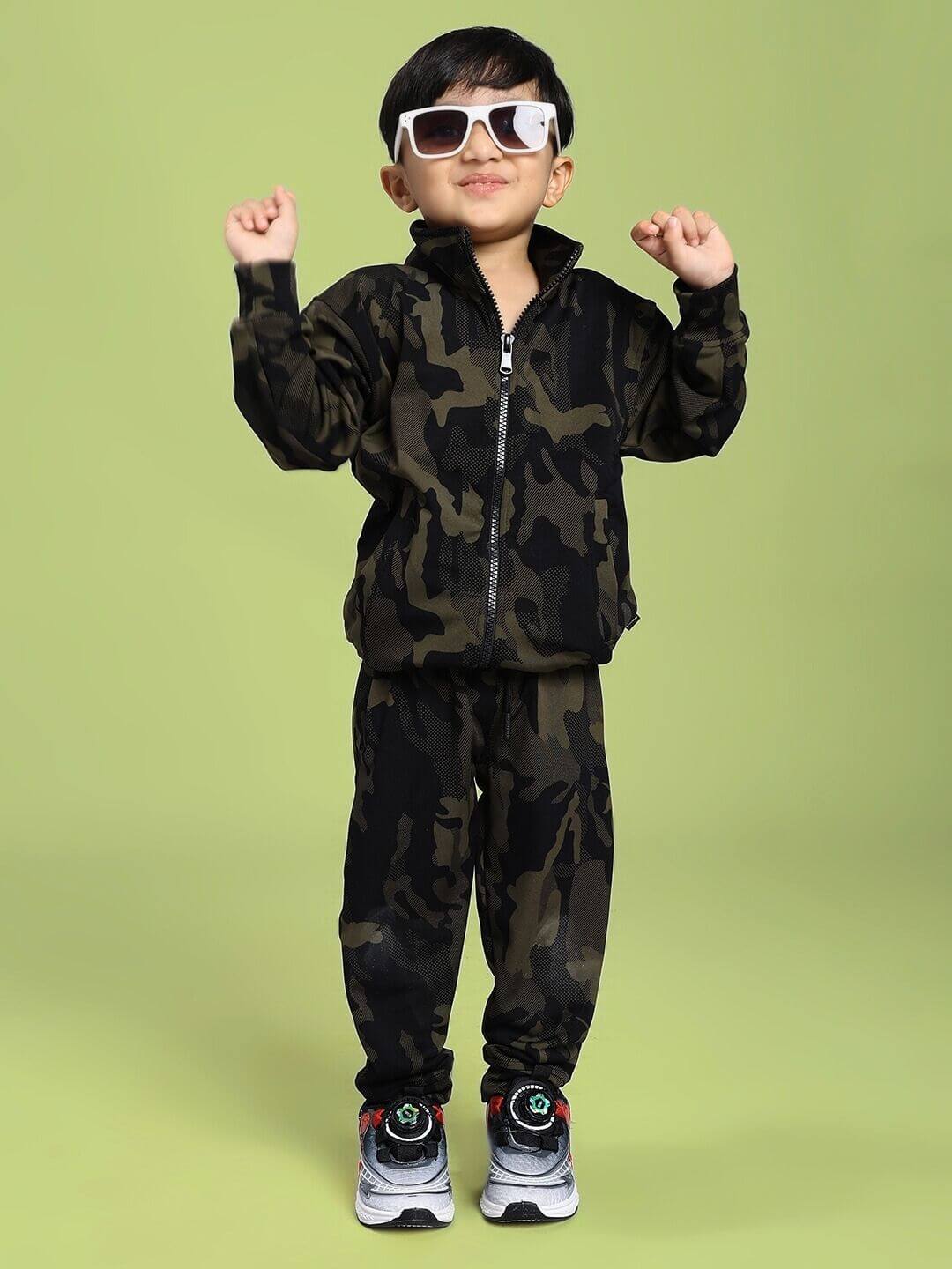 Child wearing DEFENCE CAMOFLAUGE JACKET FOR BOYS AND GIRLS CAMO GREEN posing in stylish camo outfit.