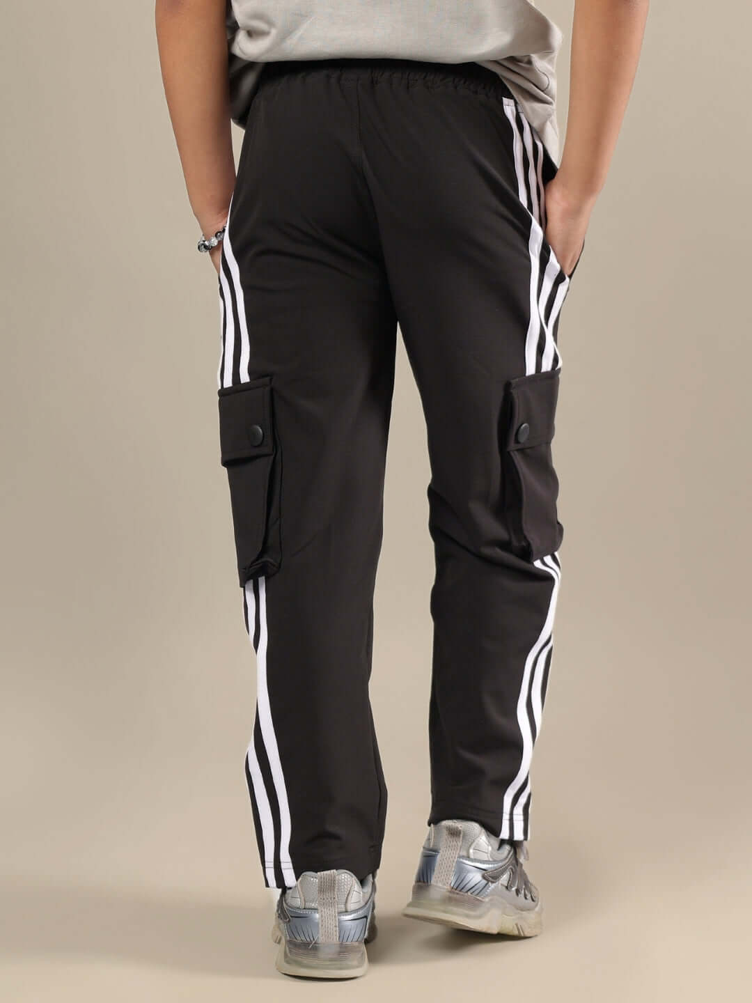 Rear view of a child wearing grey-black co-ord pants with striped pockets, showcasing DUDS design. Ideal for boys and girls.
