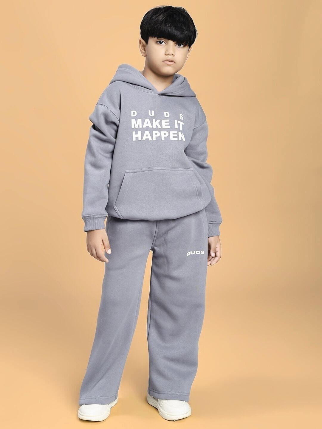 Child wearing the MAKE IT HAPPEN FLEECE CO-ORD FOR BOYS AND GIRLS GREY, standing confidently in cozy, ultra-soft brushed fleece outfit.