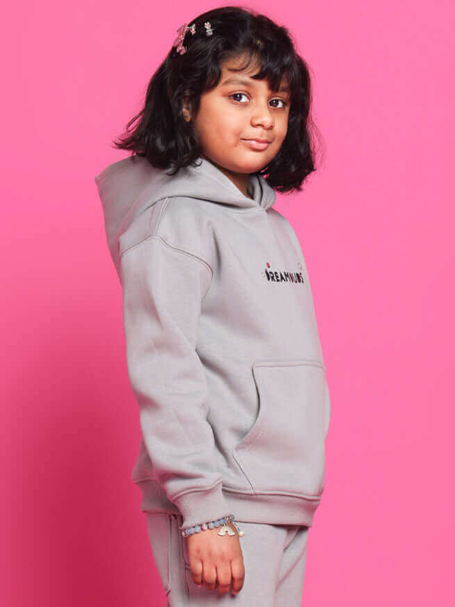Child wearing DREAM oversized hoodie in grey by DUDS, made to order by experienced tailors, available for boys and girls.