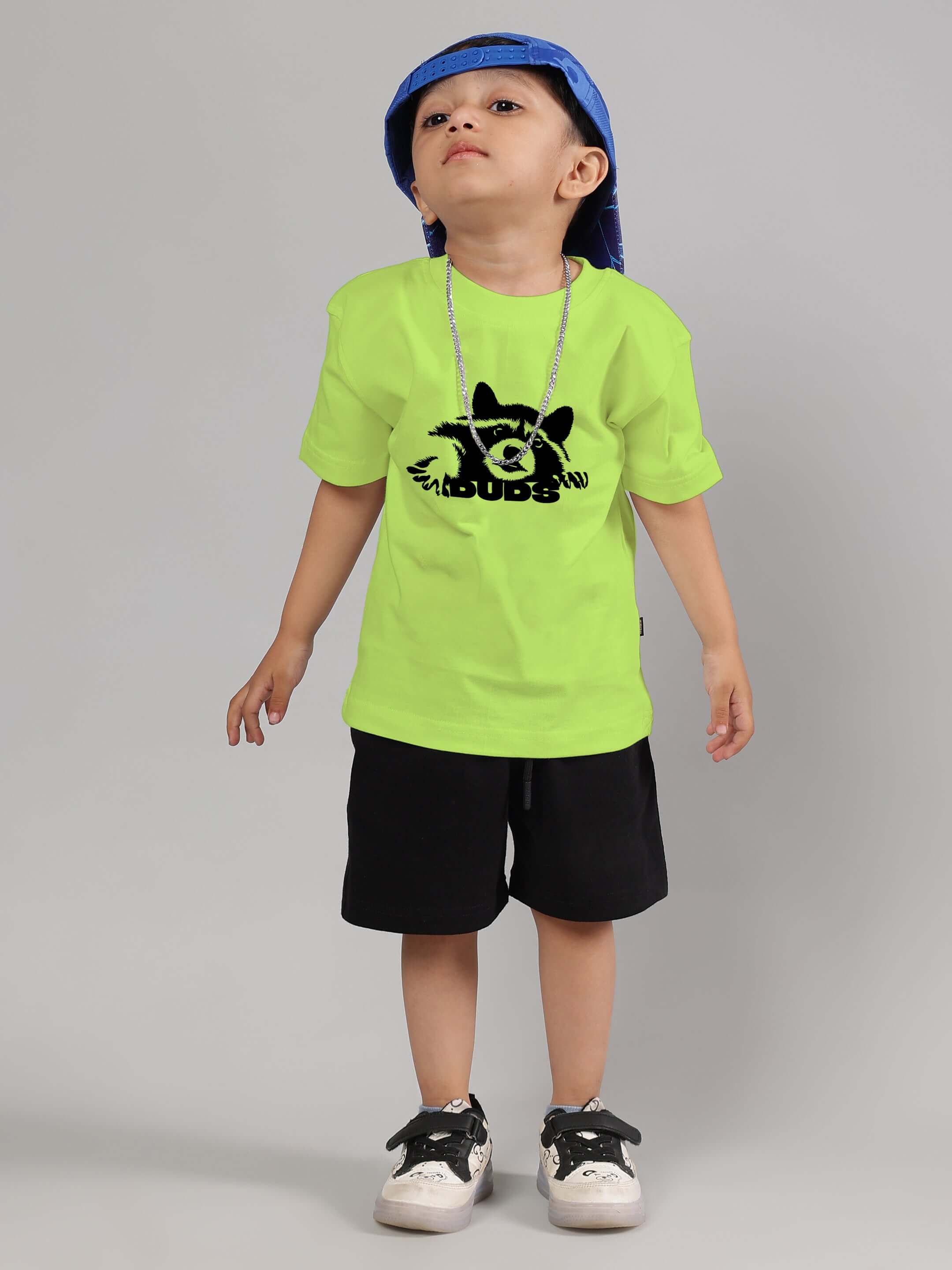 Child wearing RACCOON CO-ORD FOR BOYS GIRLS NEON GREEN-BLACK, featuring neon green t-shirt and black shorts, showcasing playful streetwear style.