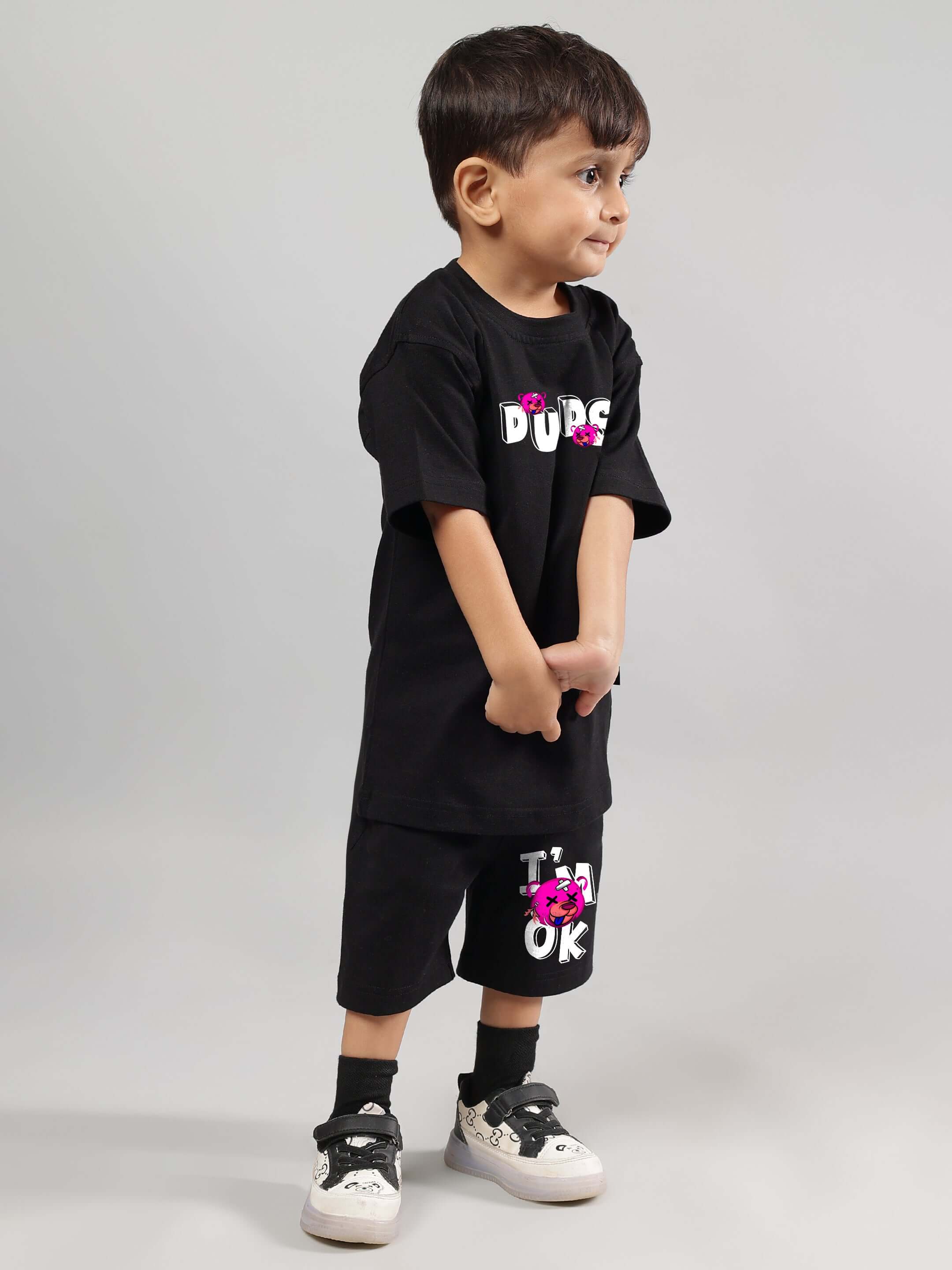 Young child wearing I'M OK black co-ord outfit for boys and girls by DUDS, featuring custom fit option for personalized sizing.