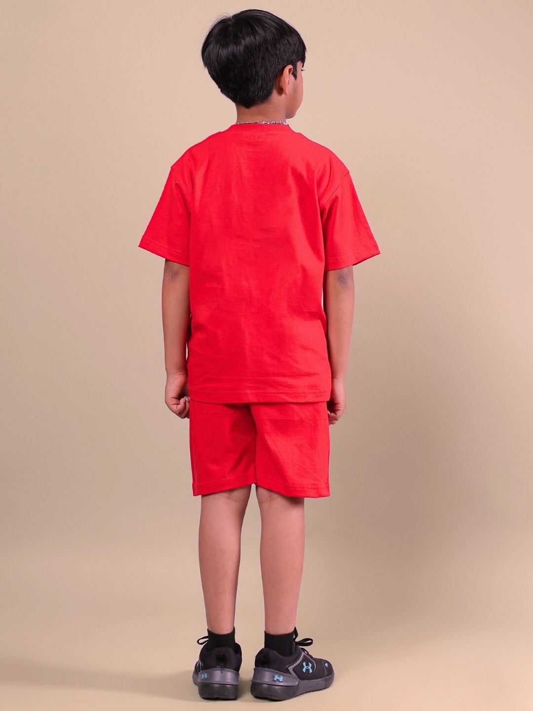 Child wearing ACE co-ord set in bold red, designed for boys and girls, showcasing vibrant style and comfort suitable for making a statement.