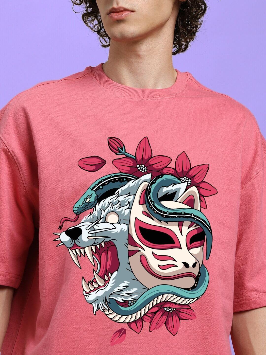 Person wearing KITSUNE WOLF PRINTED OVERSIZED T-SHIRT PINK with Japanese-inspired wolf design.
