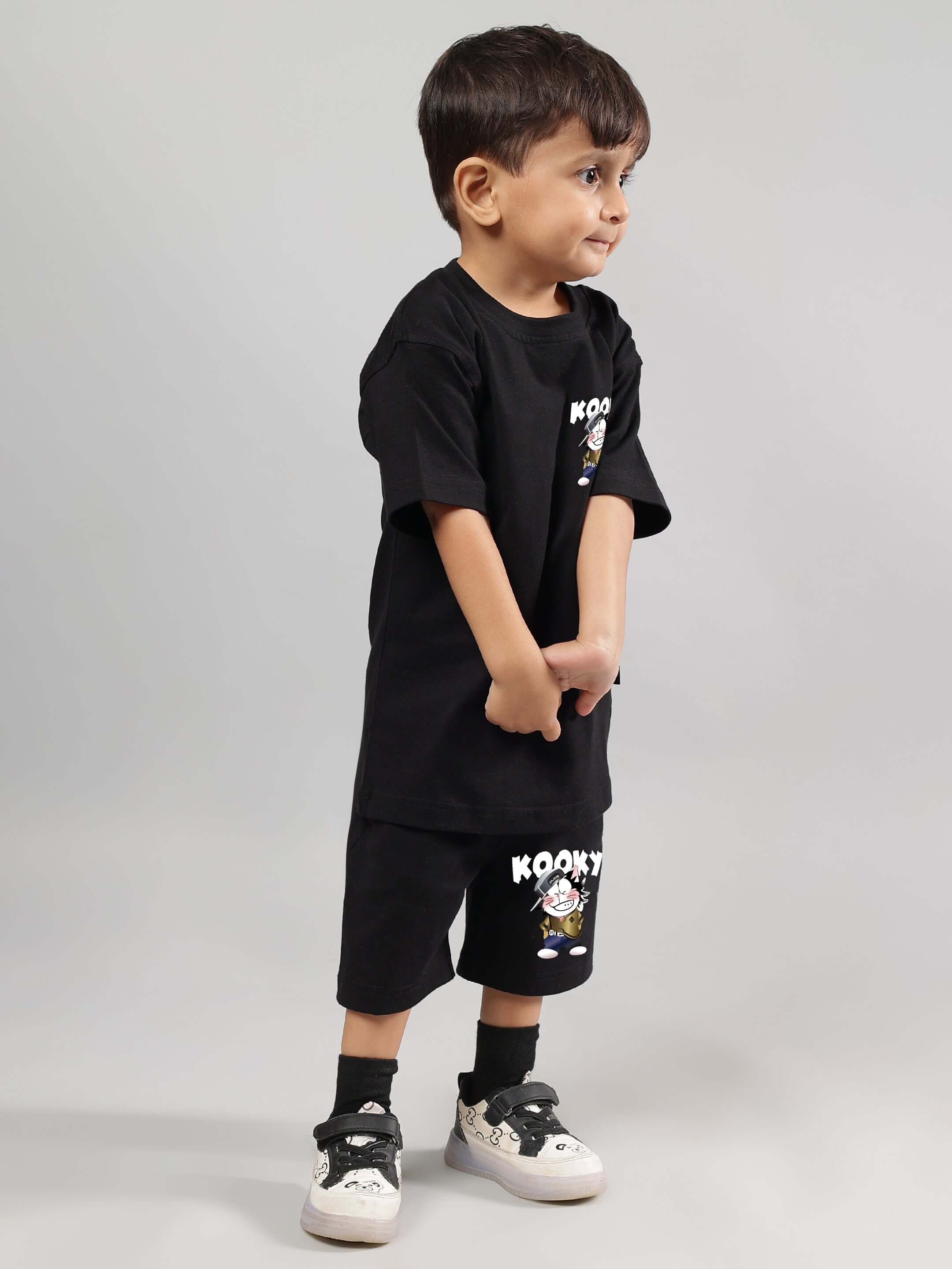 Child wearing KOOKY CO-ORD FOR BOYS GIRLS BLACK streetwear set with quirky graphic print, suitable for playful energy and all-day comfort.