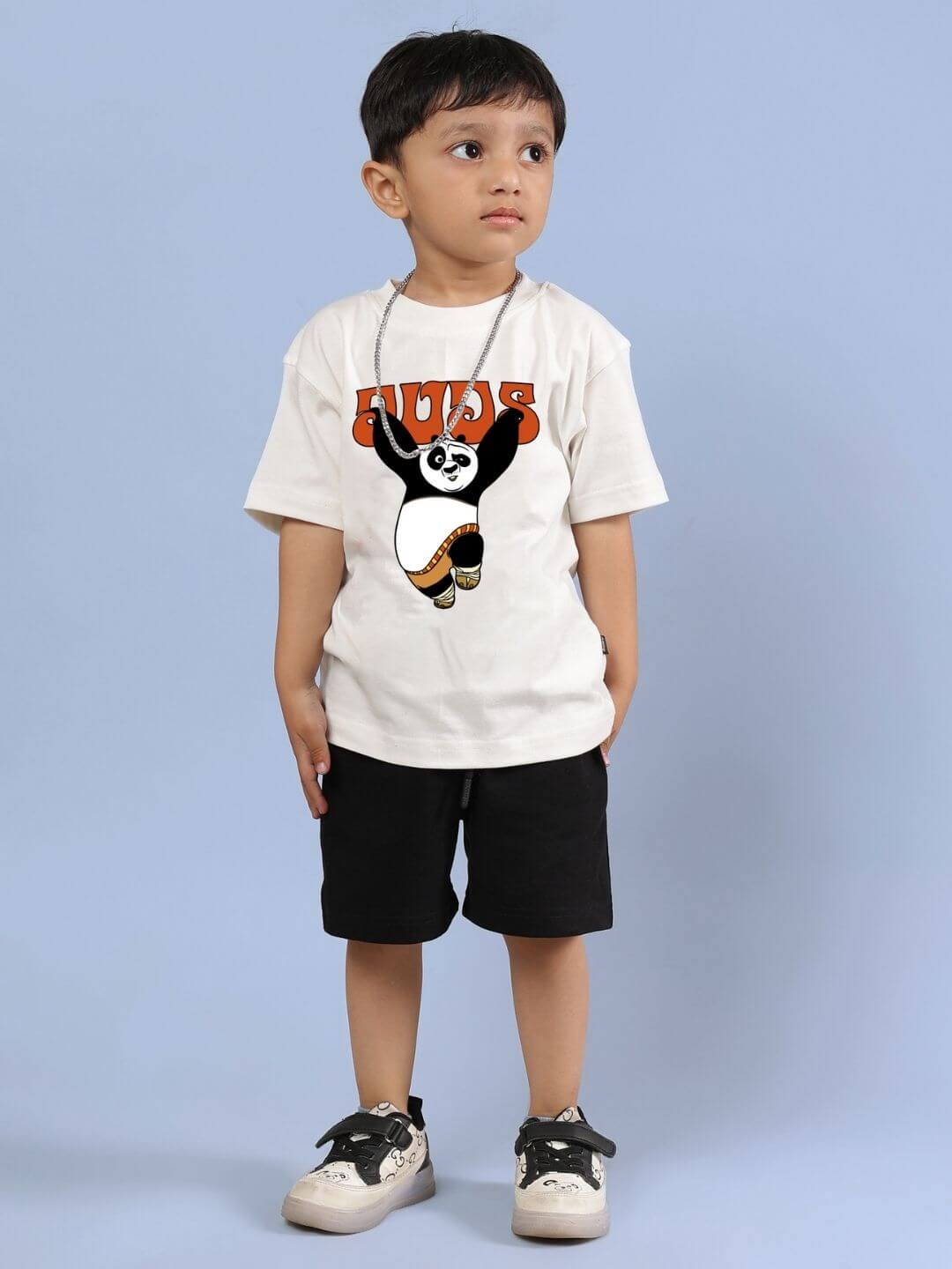 Boy wearing Kung Fu Panda co-ord set with off-white T-shirt and black shorts, ideal for casual outings and playdates.