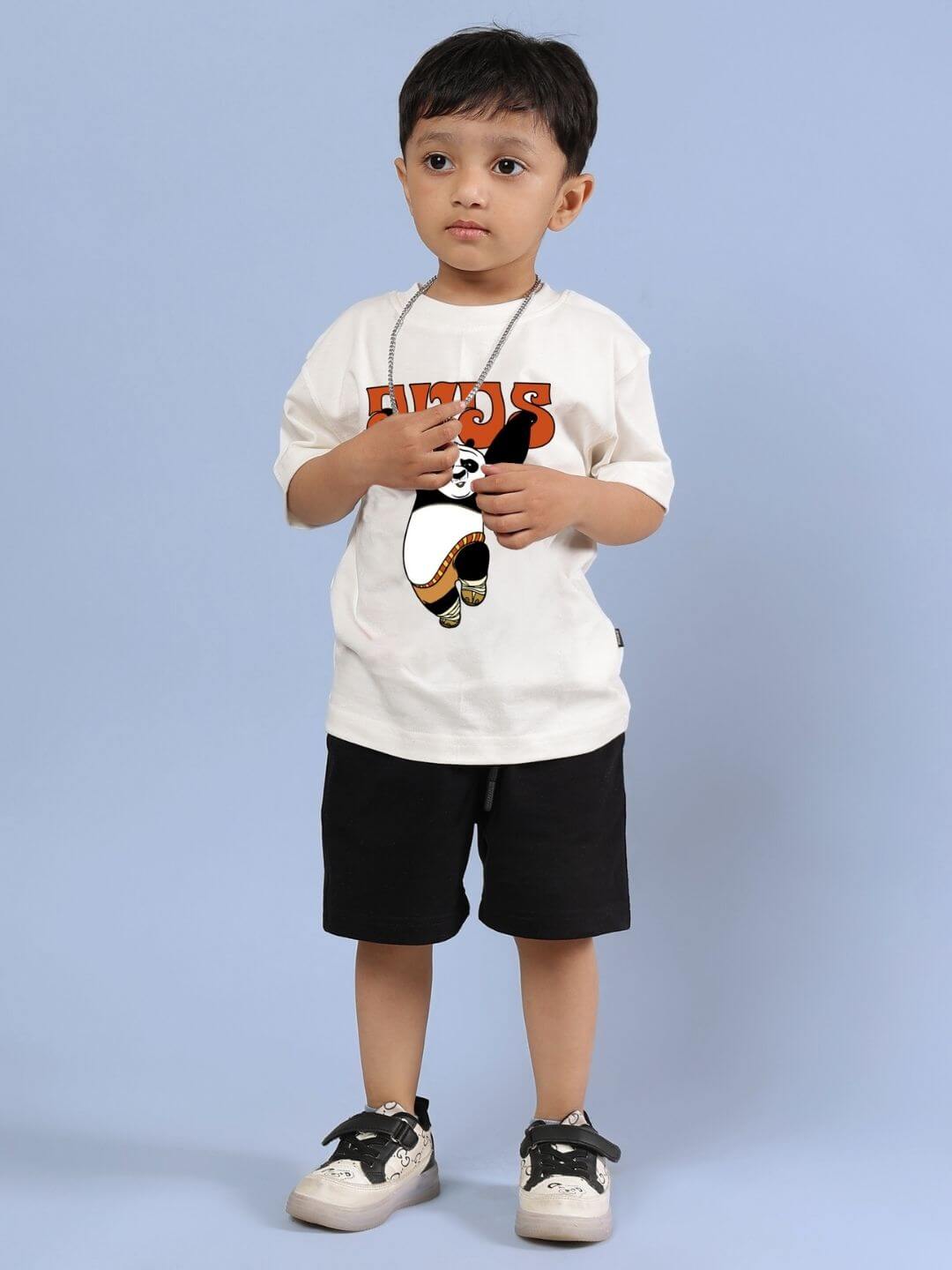 Child wearing Kung Fu Panda co-ord set with off-white T-shirt and black shorts, showcasing a playful and comfortable style.