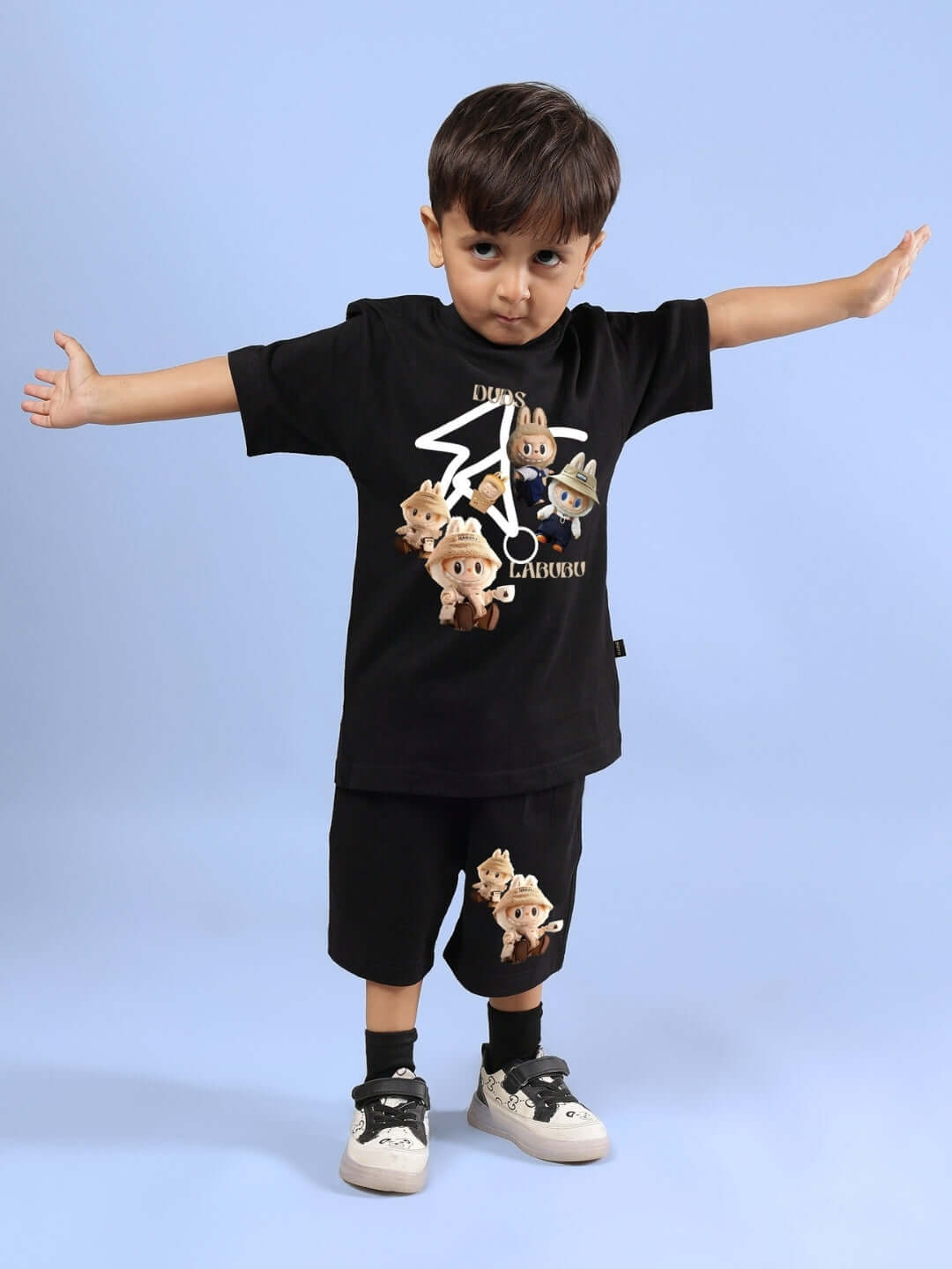 Child wearing LABUBU GANG T-SHIRT FOR BOYS GIRLS BLACK with playful Labubu print in a casual pose against a light blue background.