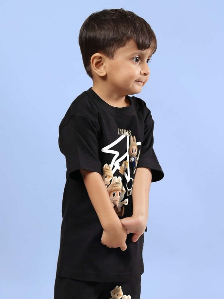 Child wearing LABUBU GANG T-SHIRT FOR BOYS GIRLS BLACK with playful graphic design on a light blue background.