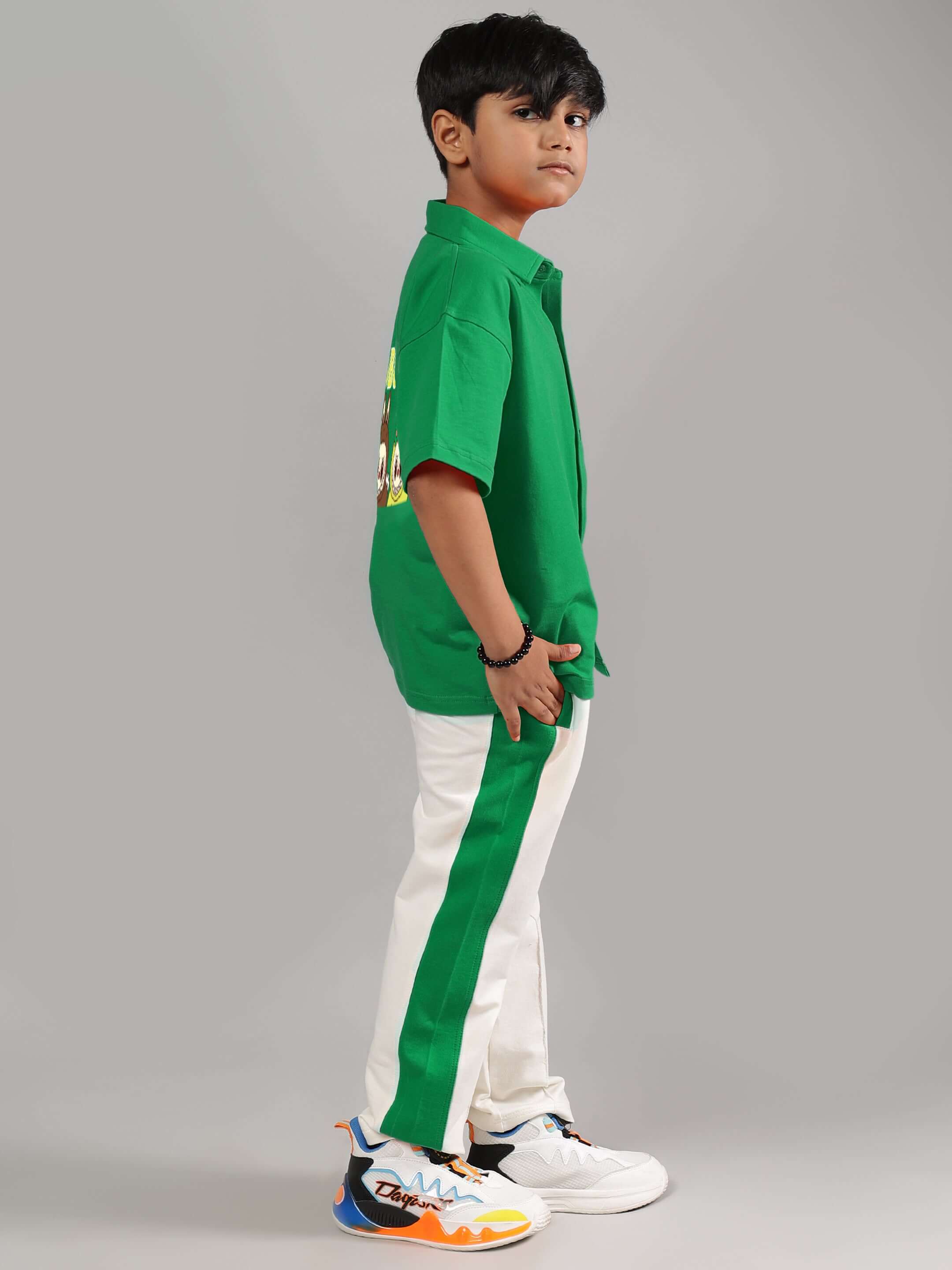 Child wearing LABUBU MYSTERY CO-ORD FOR BOYS GIRLS GREEN-OFF-WHITE, featuring a green top and white pants with green stripes, side view.