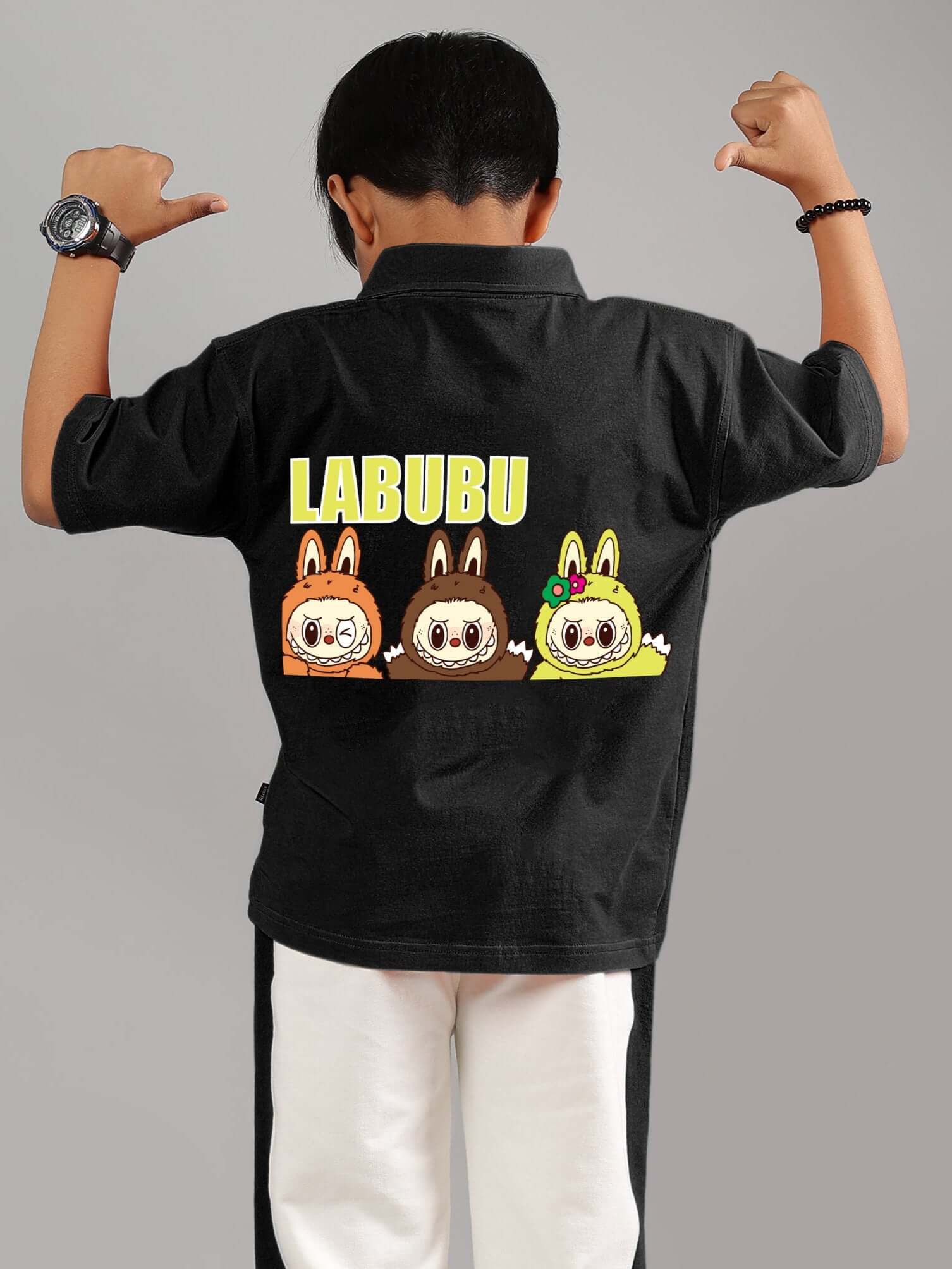 Child wearing a black Labubu mystery shirt featuring cute illustrated characters on the back.
