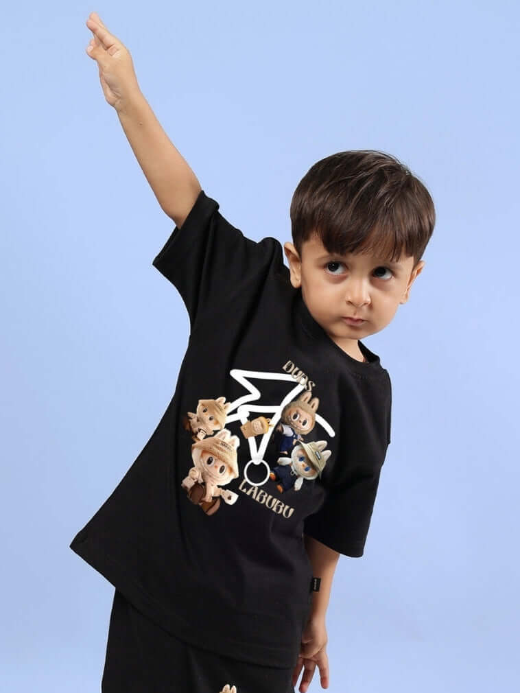 Young boy wearing a black Labubu Gang T-shirt for boys and girls, featuring playful cartoon characters on a blue background.