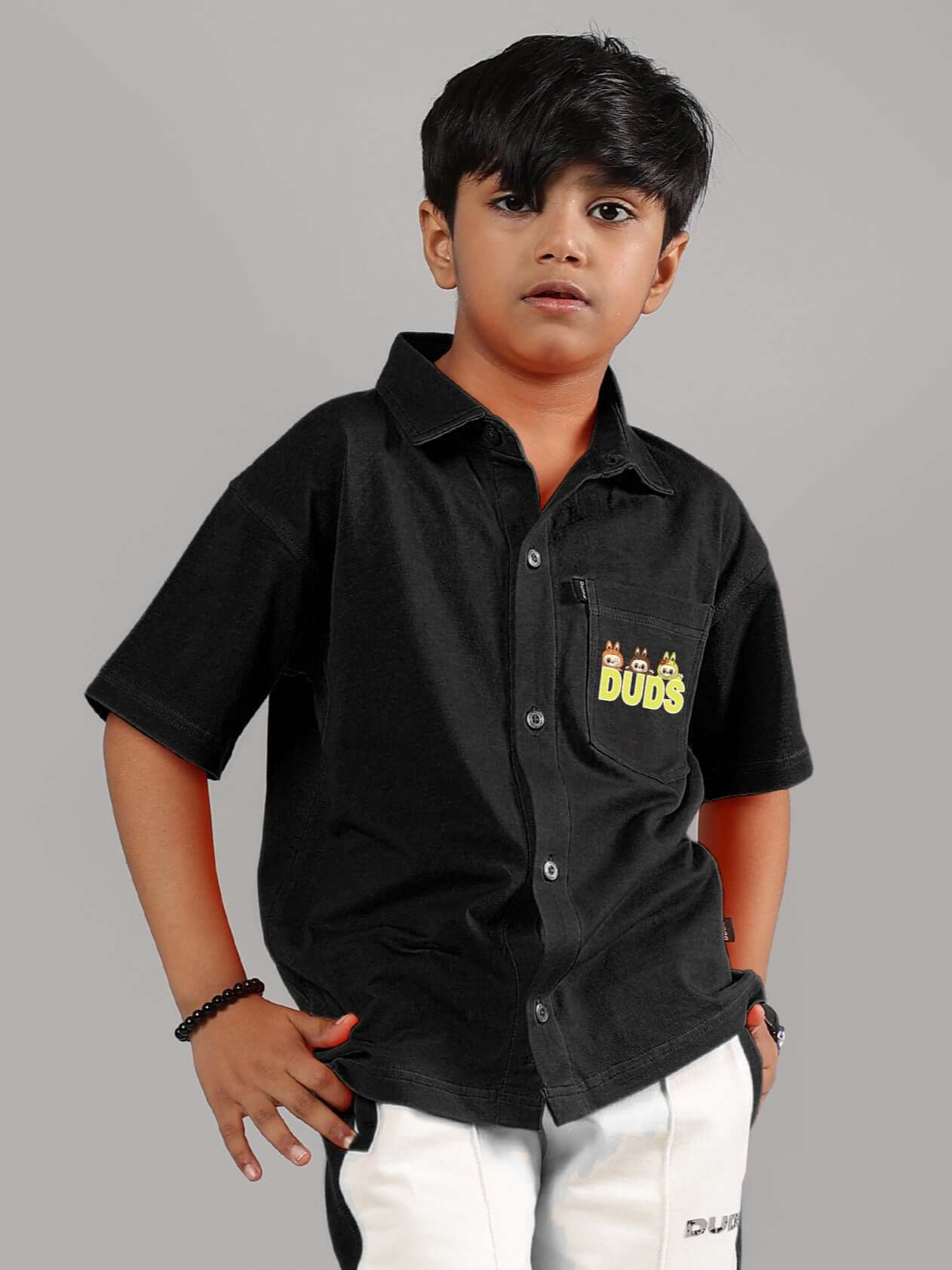 Young boy wearing black LABUBU Mystery Shirt by DUDS, made to order for boys and girls, showcasing custom fit option.