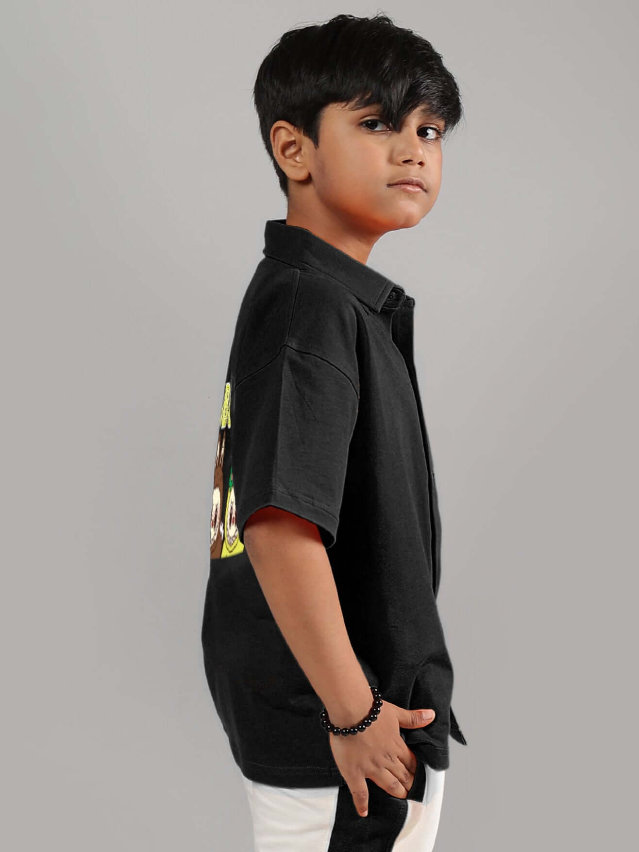 Child wearing LABUBU Mystery Shirt for Boys & Girls in Black, side view, customizable fit option available by DUDS.