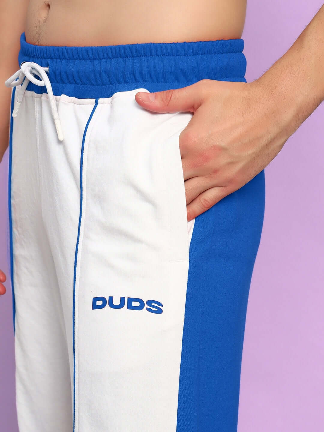 Man wearing LAGOON RELAXED FIT JOGGERS WHITE BLUE with side pocket and elastic waistband.