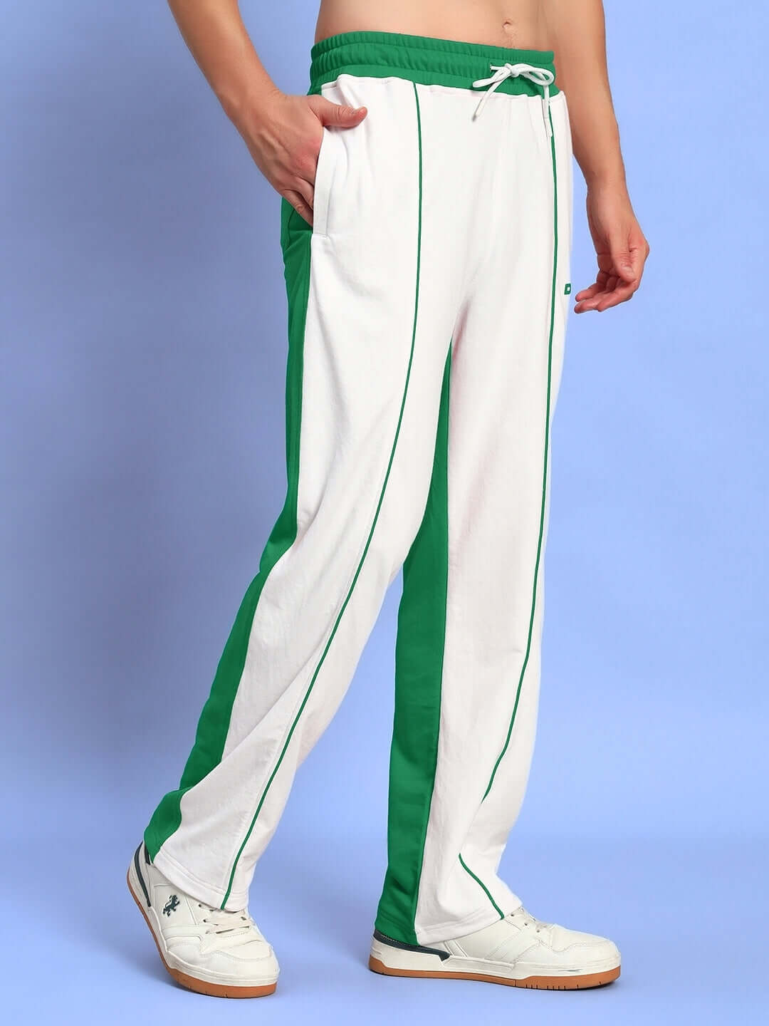 LAGOON RELAXED FIT JOGGERS WHITE GREEN pants with green stripes, side pockets, and a comfortable fit on a blue background.