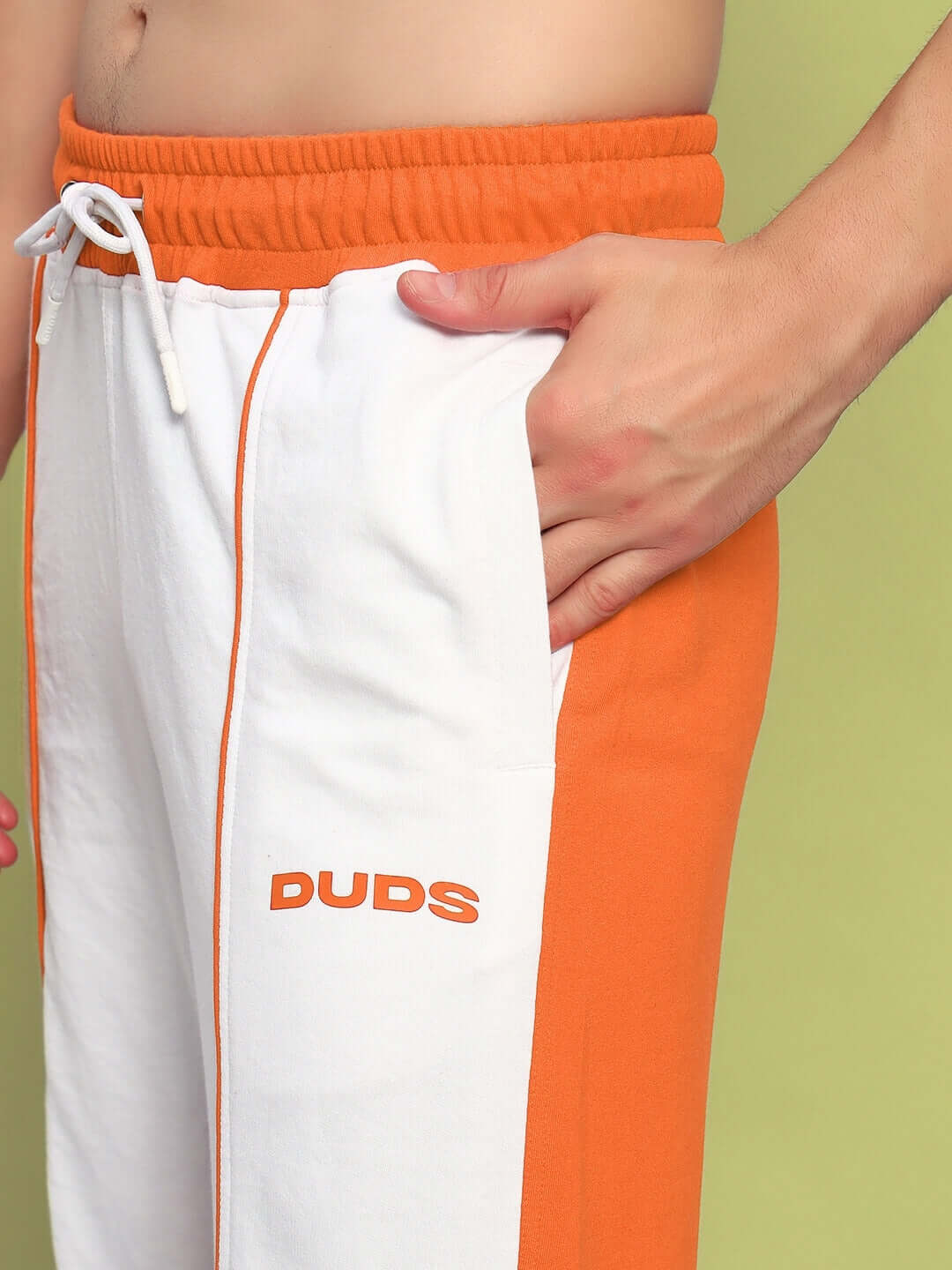 Close-up of Lagoon Relaxed Fit Joggers in white and orange by DUDS with side pocket detail and drawstring waist.