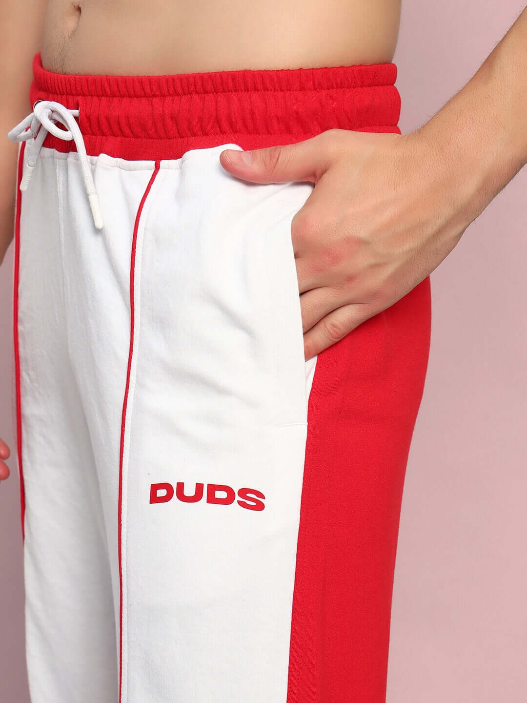 Close-up of DUDS Lagoon Relaxed Fit Joggers in white and red, showcasing the side pocket and drawstring waistband detail.