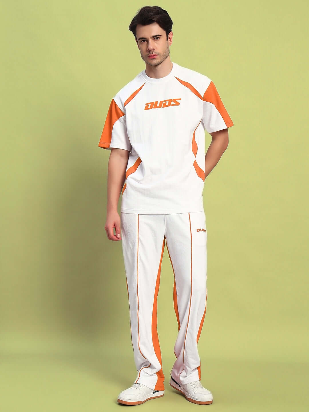 Man wearing white orange LAGOON relaxed fit joggers, tailored by DUDS, with custom fit options for prepaid orders.