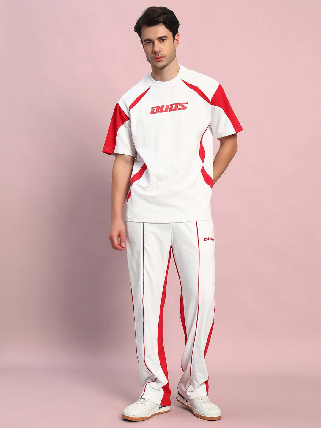 Model wearing DUDS LAGOON relaxed fit joggers in white and red, showcasing a comfortable style ideal for casual wear.