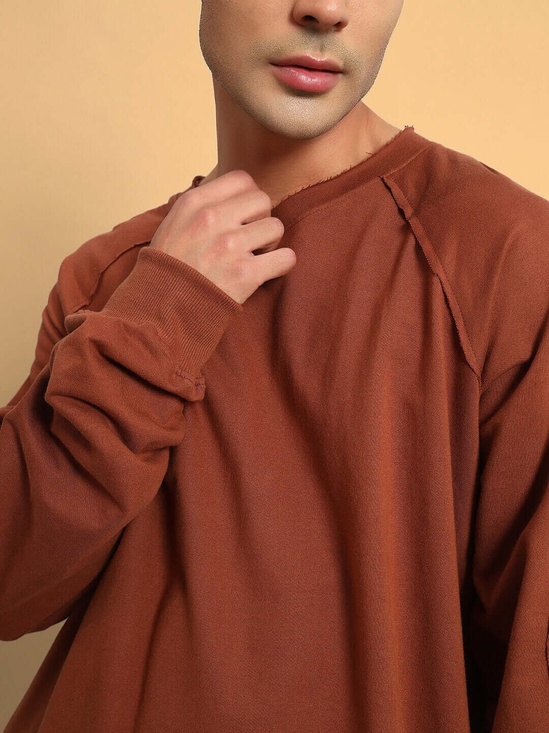 Model wearing Lamina oversized brown sweatshirt made from premium cotton French terry, showcasing its relaxed fit and rich color.