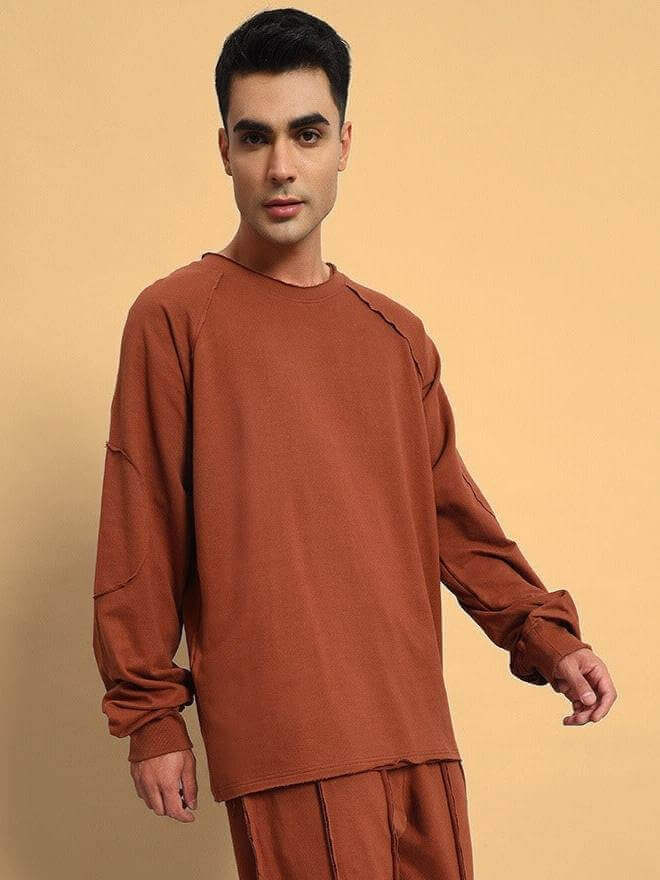 Man wearing Lamina oversized brown sweatshirt, made from premium cotton French terry with elastane, bio-washed, from India.