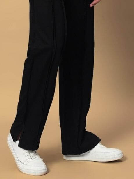 Lamina Side Slit Joggers in black worn with white sneakers, showcasing casual style and customizable fit options from DUDS.