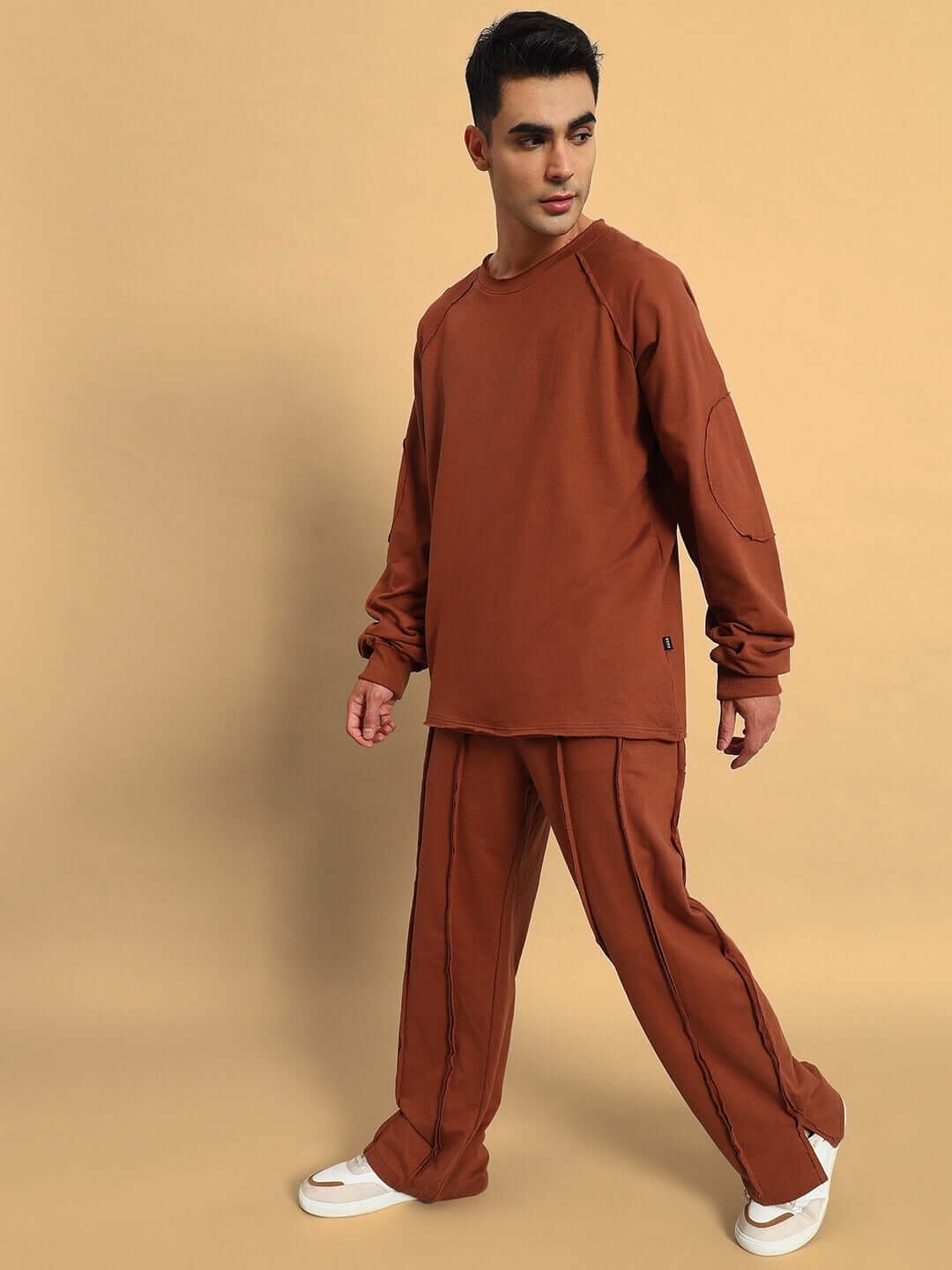 Alt Tag: Model wearing Lamina Side Slit Joggers in Brown with matching top, showcasing relaxed fit and side slit design.