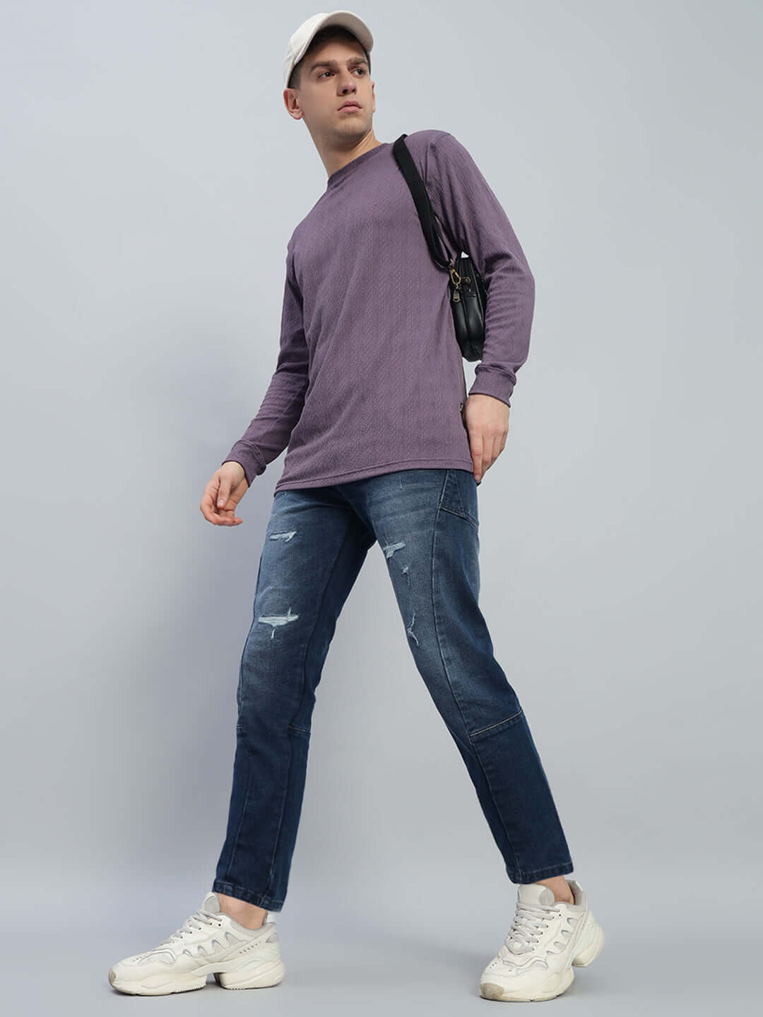 Model wearing Lavish Regular Fit Denim Jeans in blue, paired with a casual top and sneakers, showcasing a contemporary style.