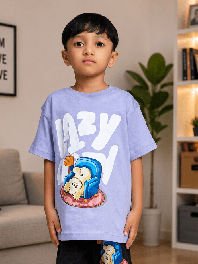 Boy wearing LAZY DAY T-SHIRT FOR BOYS GIRLS LAVENDER with a fun graphic design in a cozy interior setting.