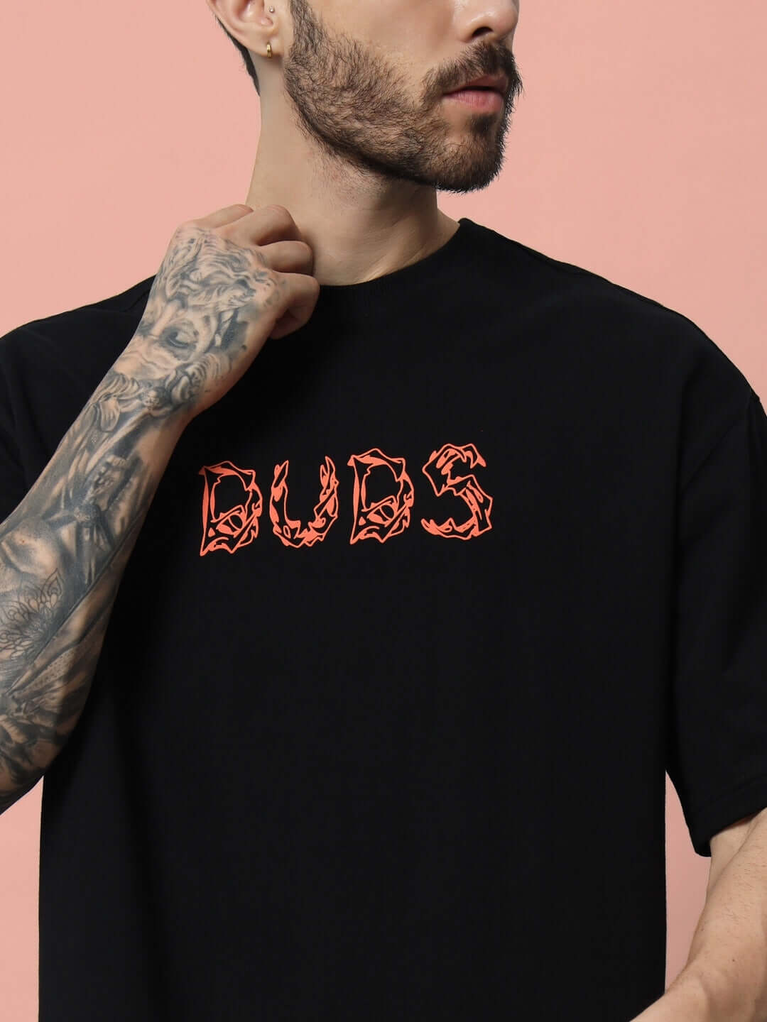 Man wearing LEO PUFF black t-shirt with DUBS print, premium cotton fabric, over-sized fit, stylish and comfortable fashion.