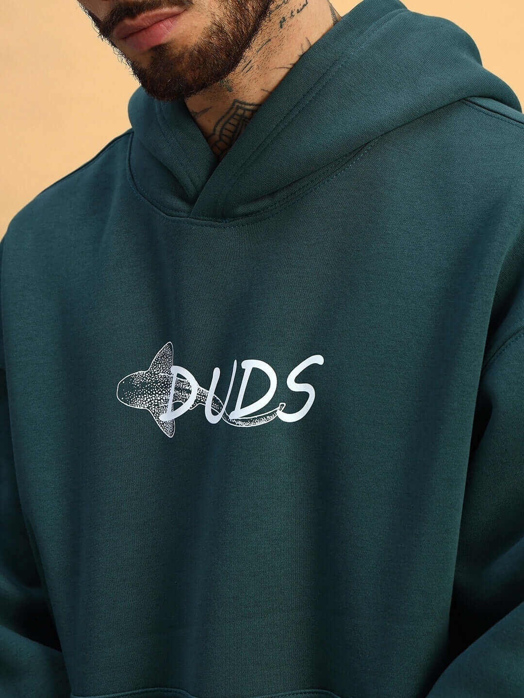 Close-up of LEOPARD SHARK FLEECE HOODIE TEAL GREEN with DUDS logo design.