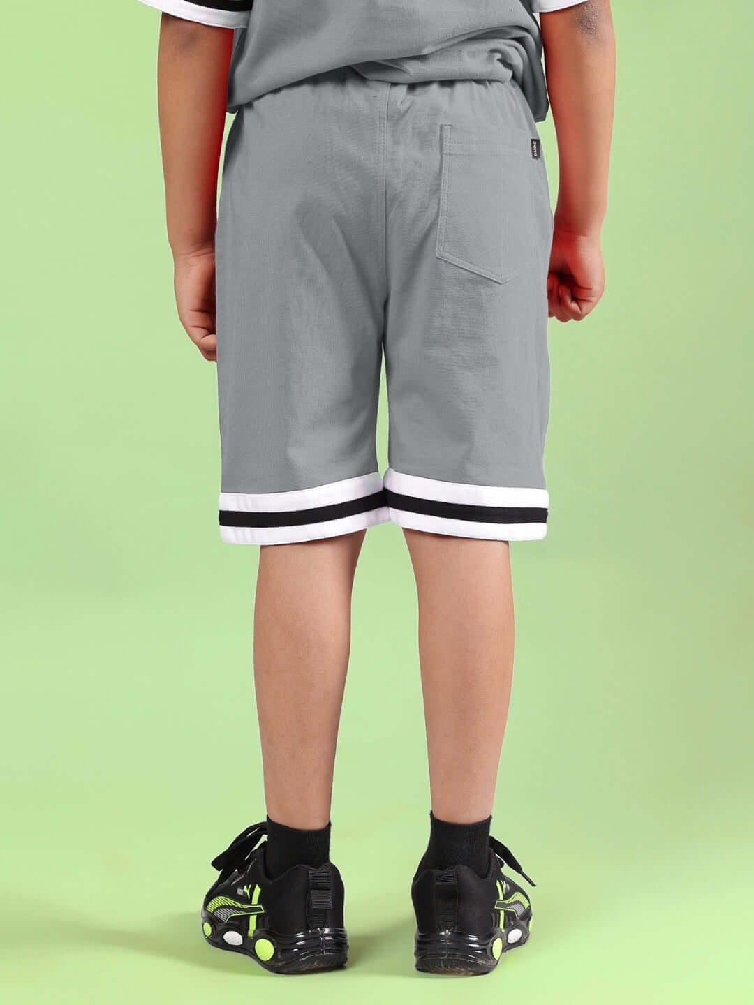 Rear view of grey printed co-ord shorts for boys and girls, featuring stylish white stripes and comfortable fit, made by DUDS.