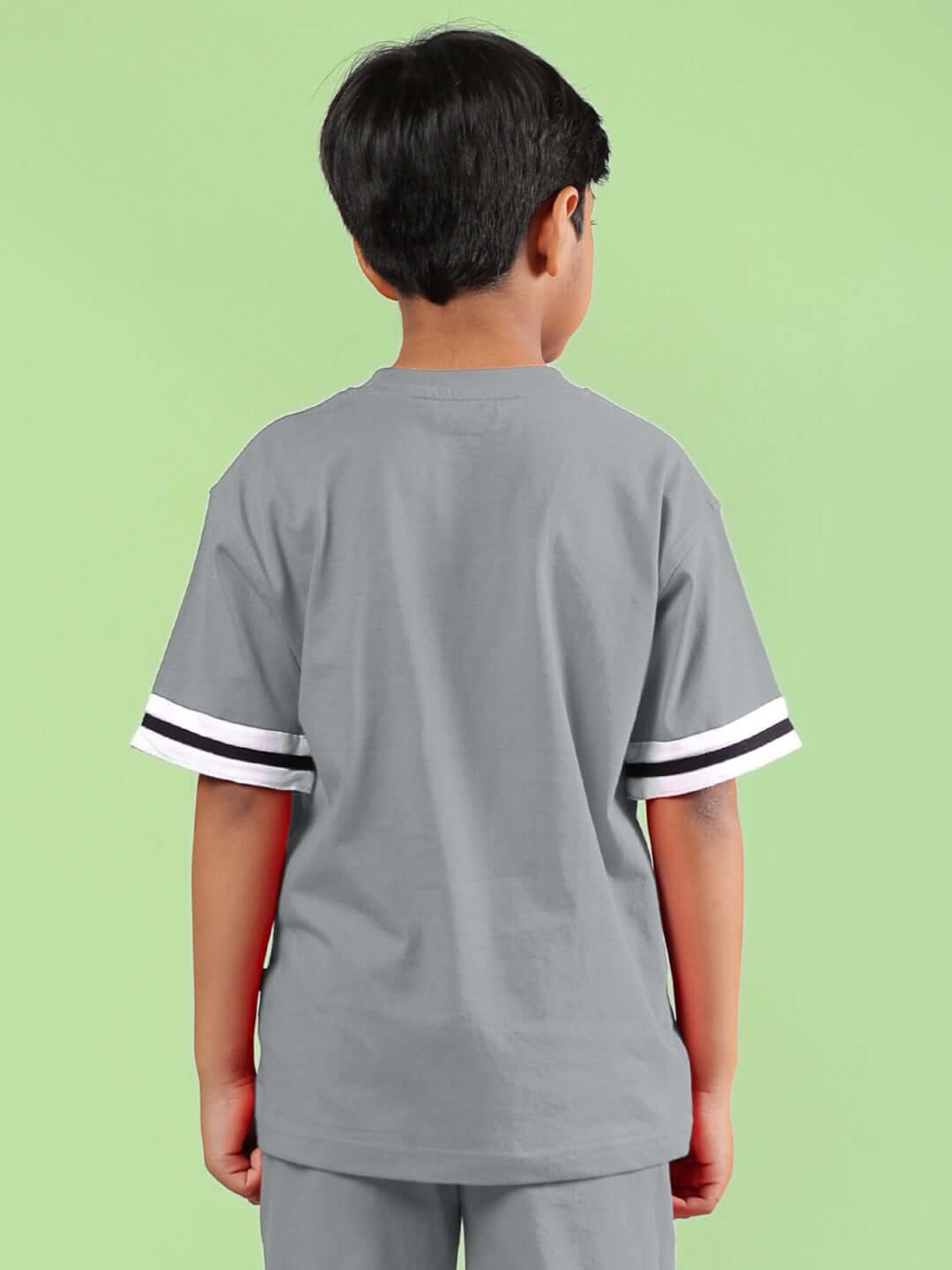 LETS GO PLAY PRINTED T-SHIRT FOR BOYS & GIRLS GREY, back view of child wearing the t-shirt on green background.