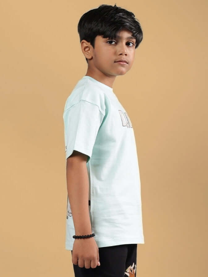 LET'S ROCK T-SHIRT FOR BOYS & GIRLS SKY BLUE modeled by a child in a side pose, showcasing the design and fit.