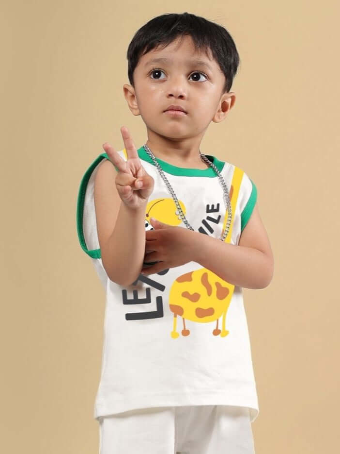 Child wearing LET'S SMILE T-SHIRT FOR BOYS AND GIRLS OFF WHITE with cheerful print, standing against a neutral backdrop.