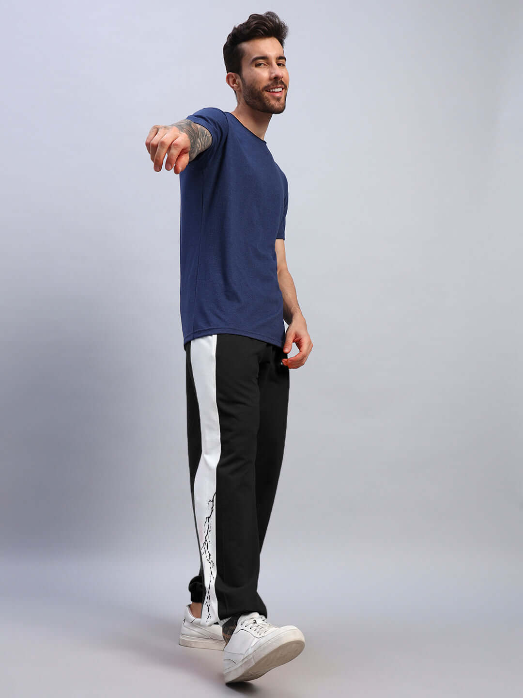 Man wearing LIGHTNING BOLT RELAXED FIT JOGGERS BLACK-WHITE, showcasing streetwear style with bold black-and-white contrast.