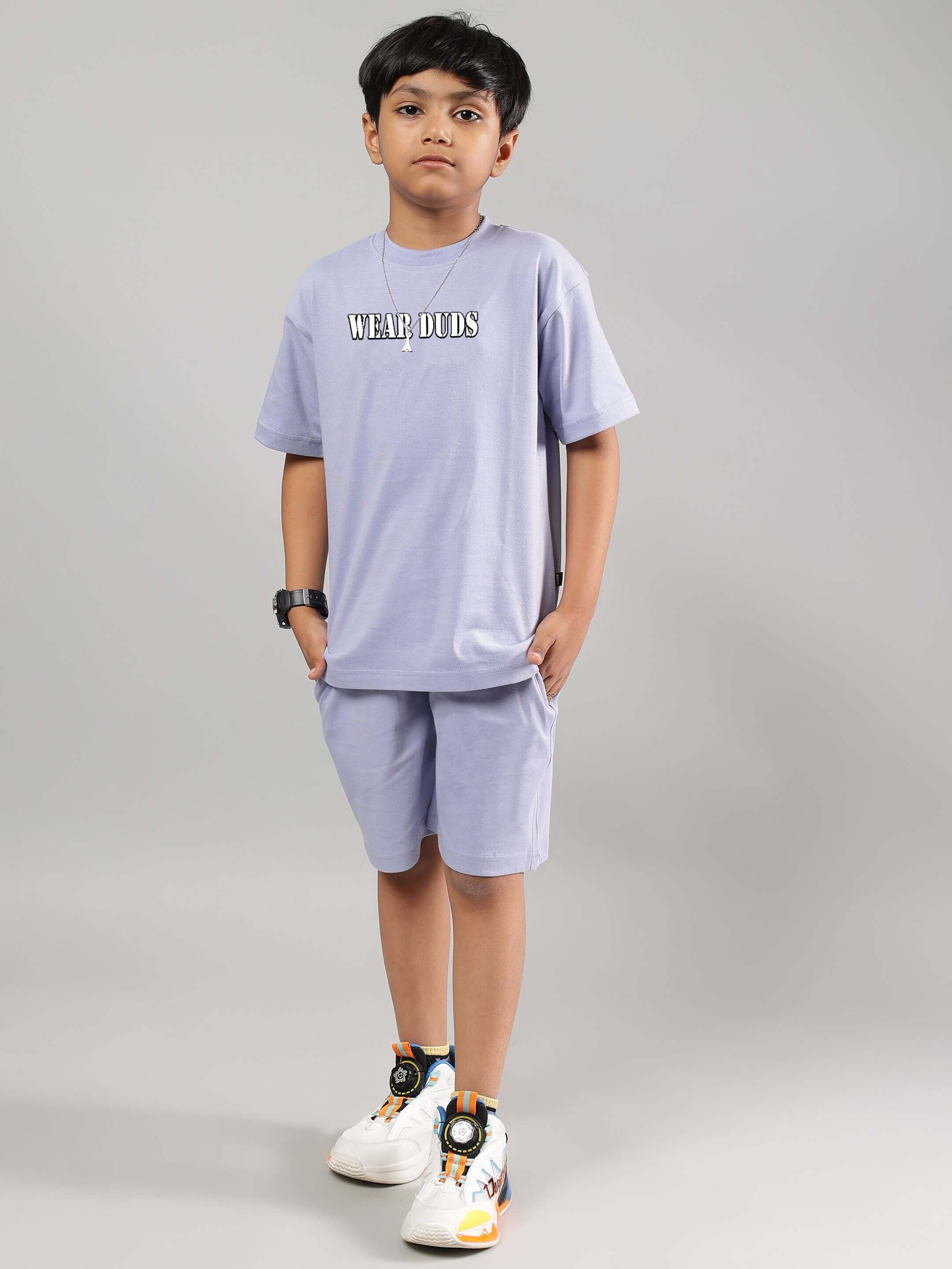 Boy wearing a lilac rapper bunny t-shirt and shorts from DUDS, ideal for boys and girls. Comfortable, customizable fashion.