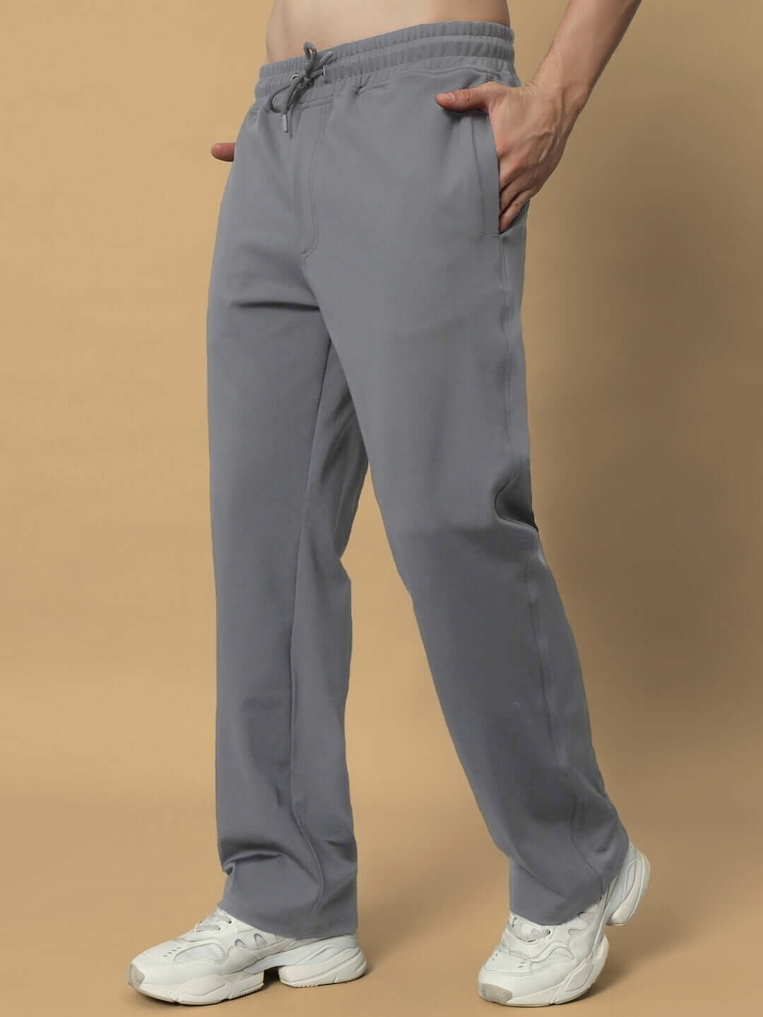 Person wearing grey LIMBER RELAXED PANT JOGGER with white sneakers