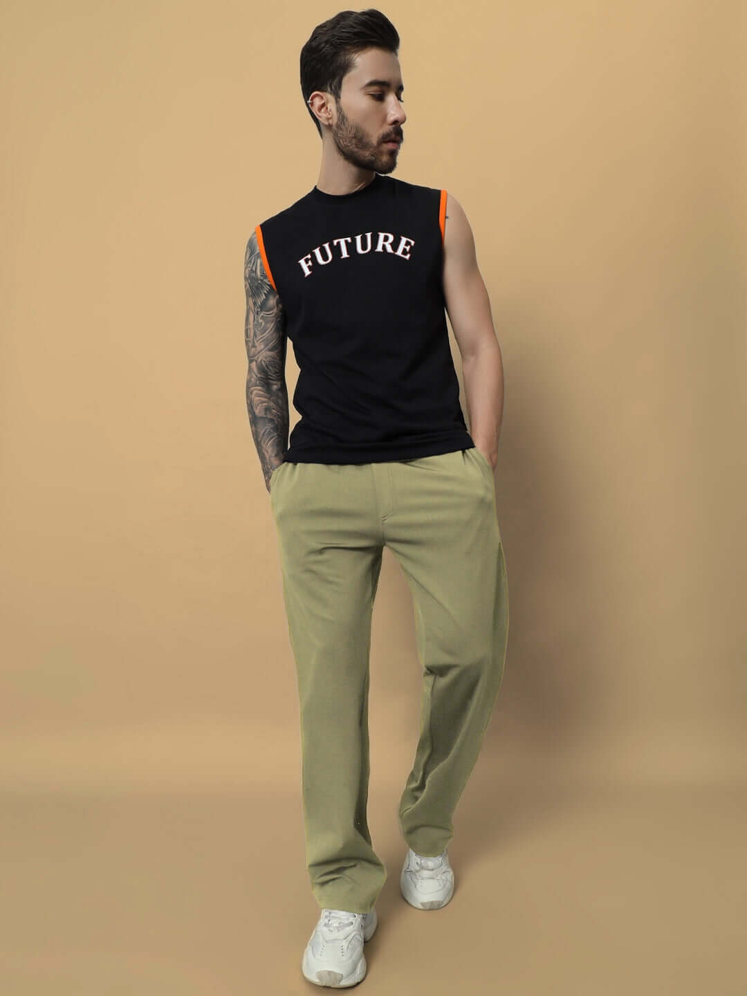 Man wearing olive green jogger pants with black 'Future' tank top