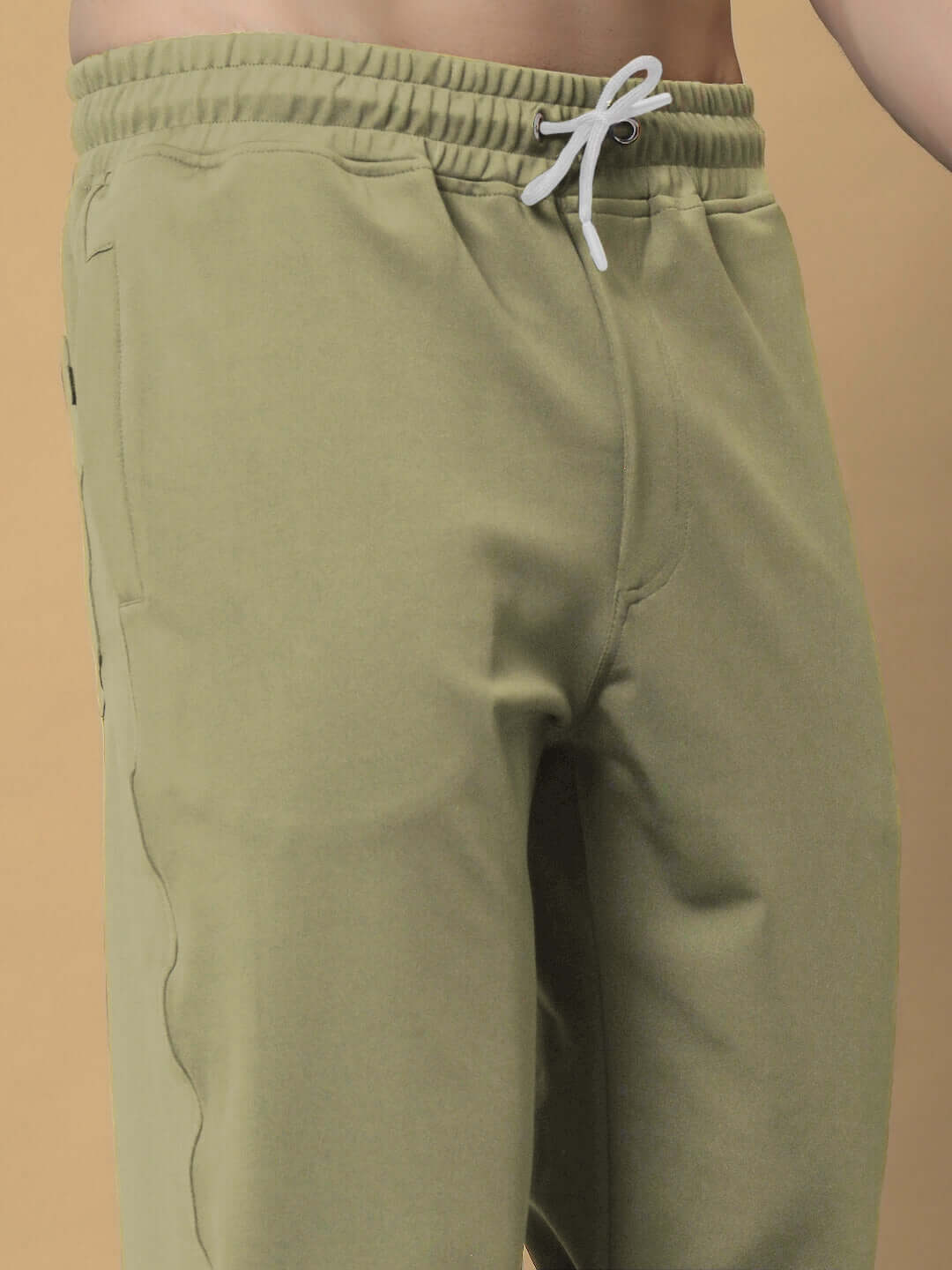 Olive green relaxed jogger pants by DUDS with adjustable drawstring waist, showcasing comfort and custom fit options.