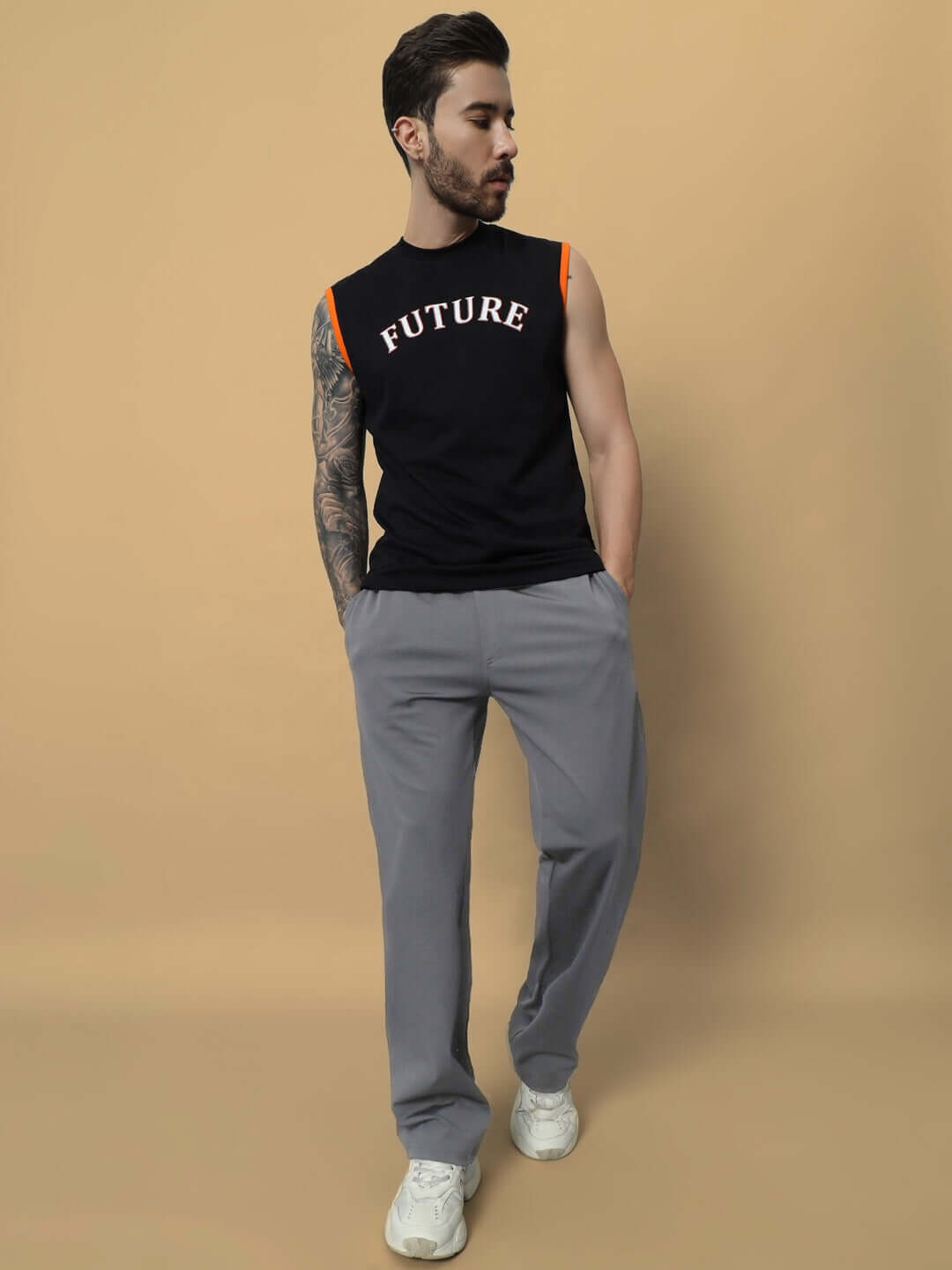Man wearing grey LIMBER RELAXED PANT JOGGER with black sleeveless shirt, posing in a studio setting.