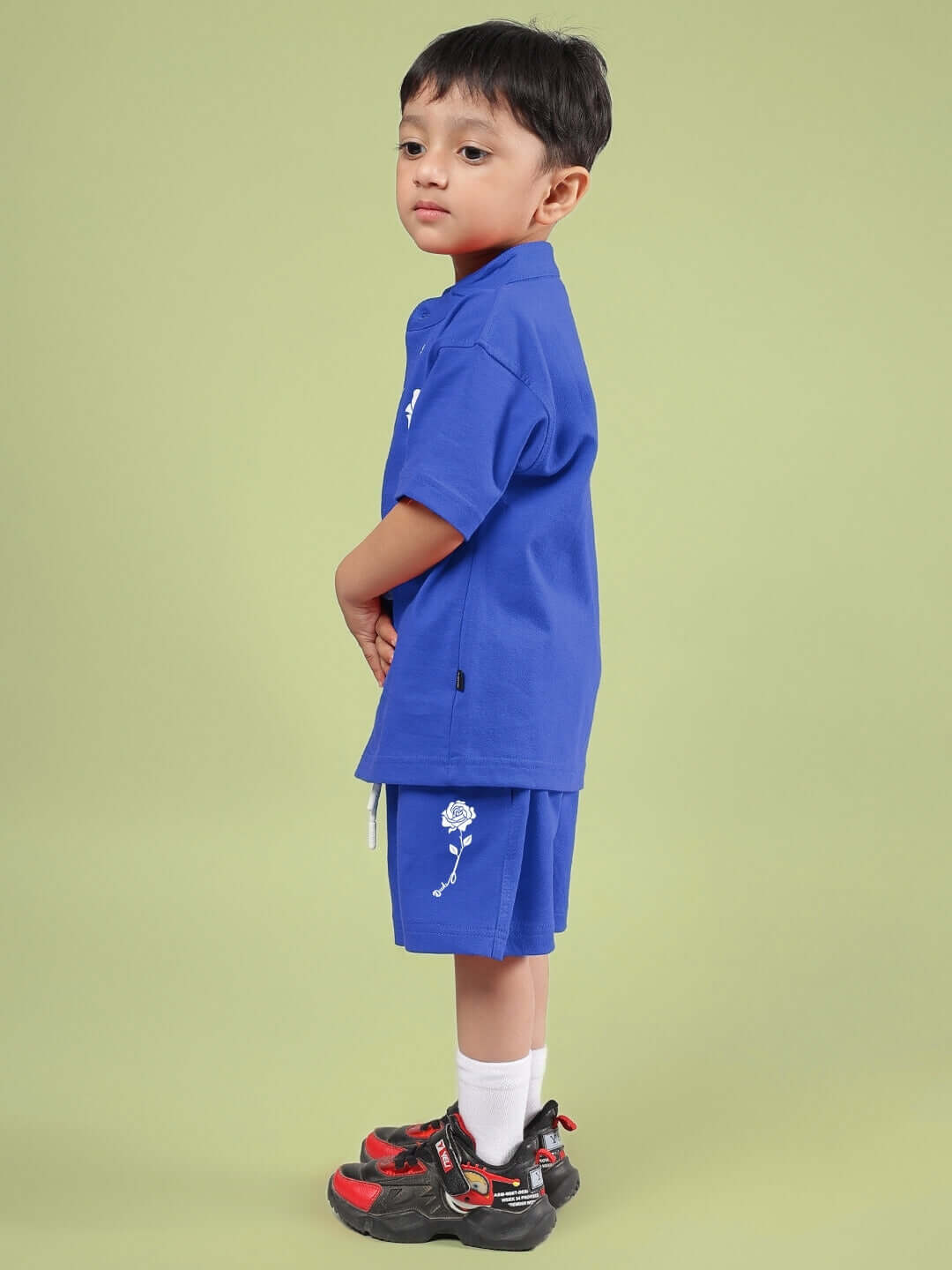 Child wearing LIMBO CO-ORD FOR BOYS & GIRLS BLUE, featuring a blue shirt and shorts set made from breathable cotton-blend fabric.